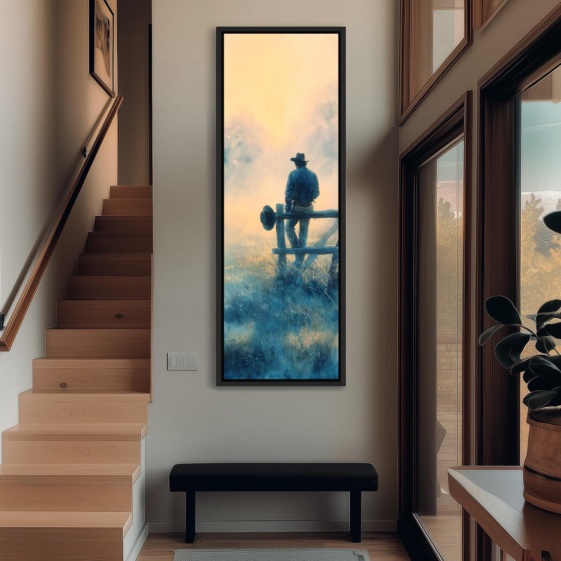 a large framed painting of a cowboy standing on a fence, with a serene landscape in the background.