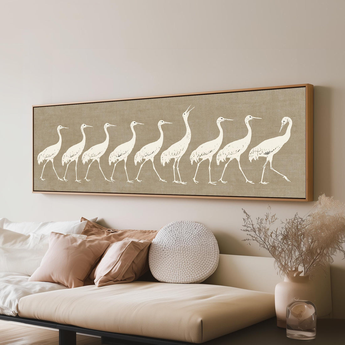 Procession of white cranes on linen long horizontal canvas print above a sofa in a living room