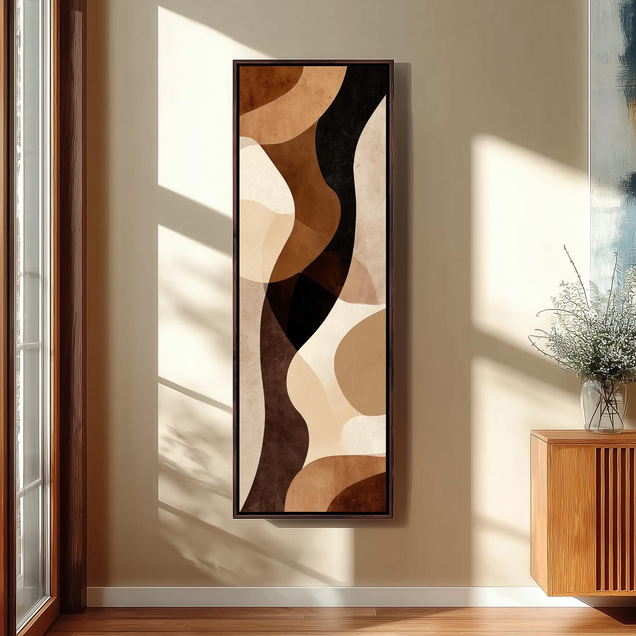 a large abstract painting hanging on a wall in a room with a wooden floor and a window.