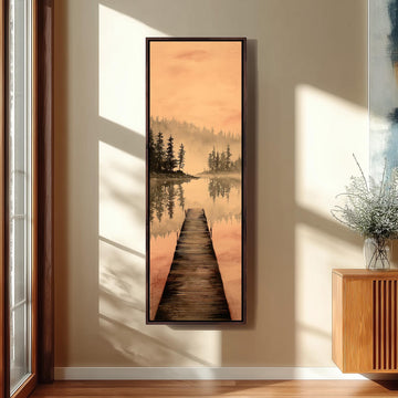 a large framed painting hanging on a wall, depicting a wooden dock leading to a serene lake surrounded by trees.