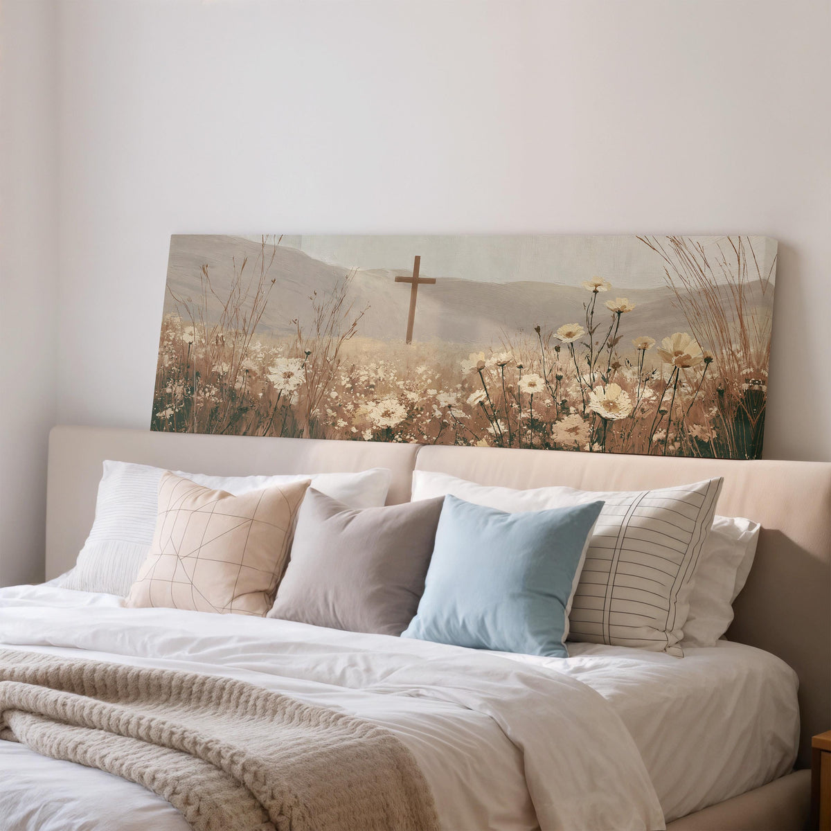 Wooden cross in a cream wildflower field wide panoramic canvas print above a bed in a bedroom
