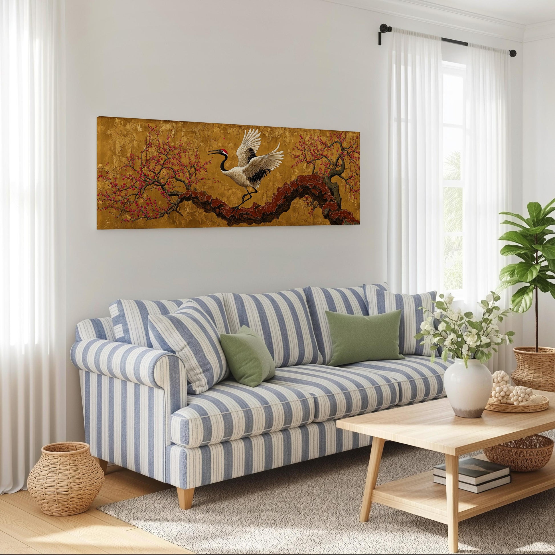 a living room with a striped blue and white sofa, a wooden coffee table, and a large painting of a crane in flight on the wall.