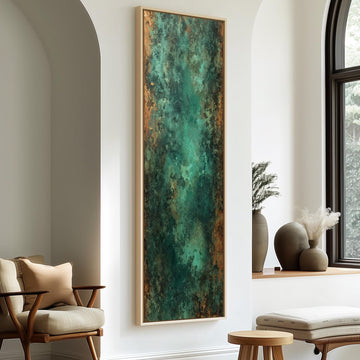 a modern living room with a large abstract painting hanging on the wall, a wooden chair, a small table, and a window with a plant on the sill.