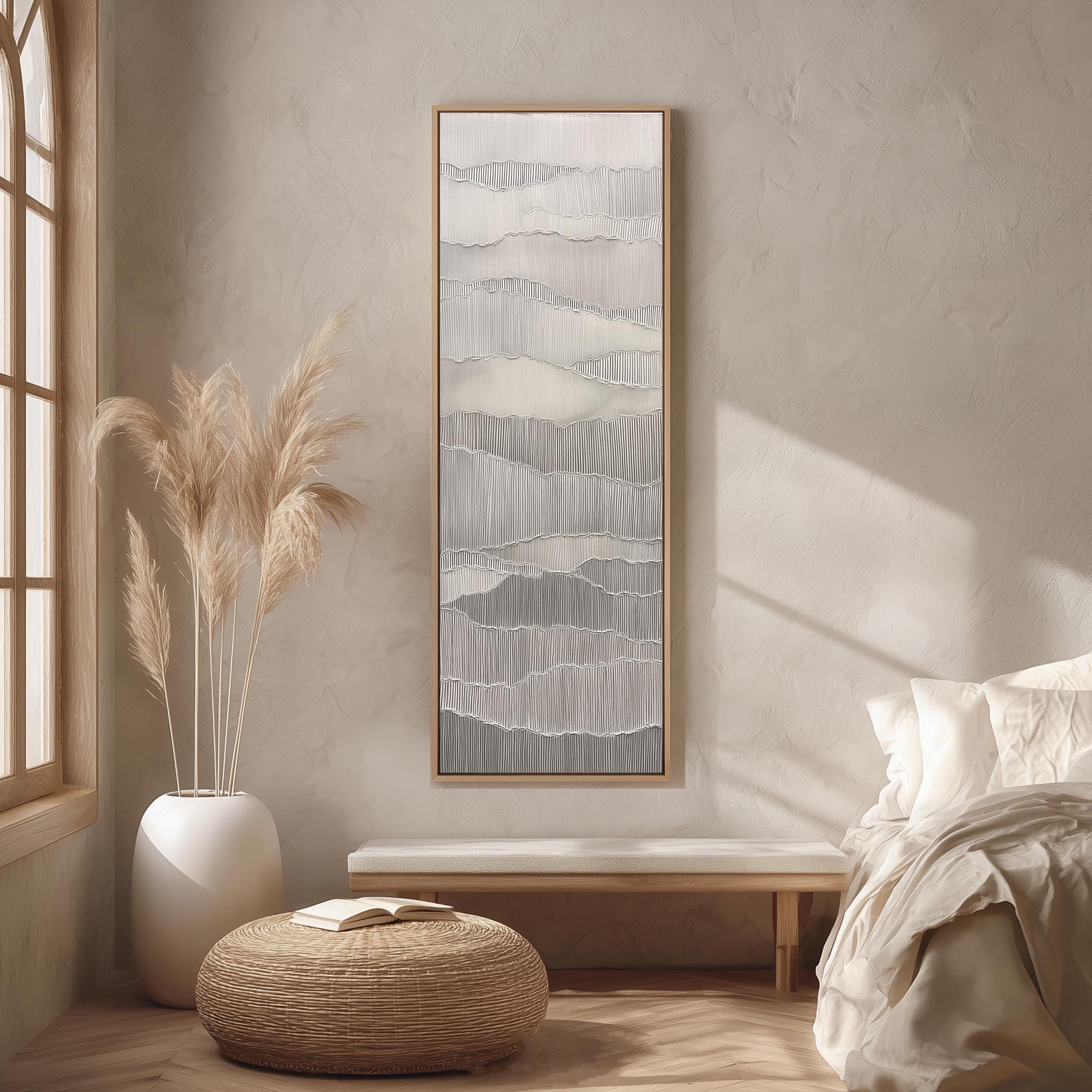 a serene and minimalist bedroom with a large abstract painting hanging on the wall, a white bed with a white pillow, a white wicker ottoman, and a tall potted plant with long, feathery branches.
