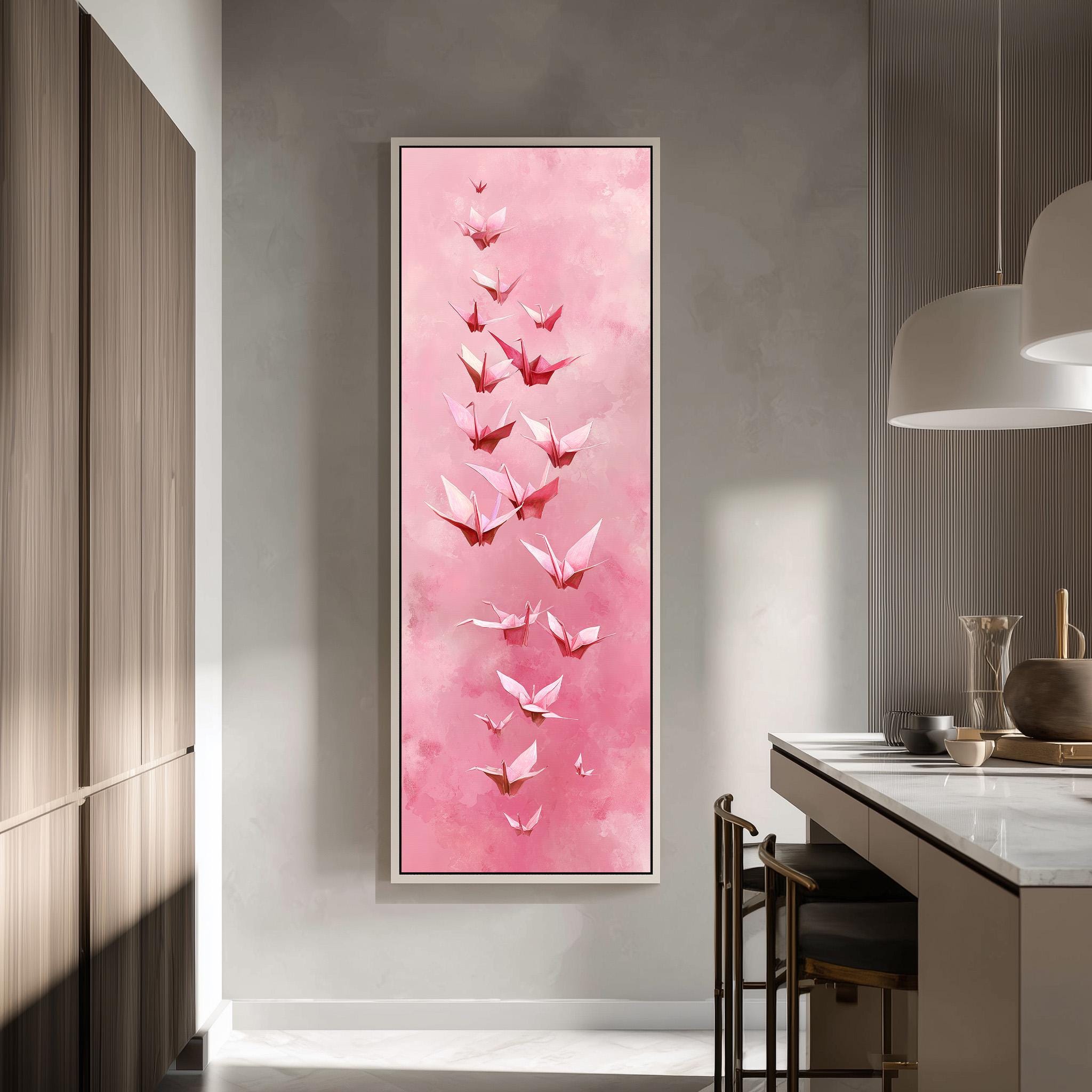 a large, framed painting of pink origami birds hanging on a wall in a modern kitchen.