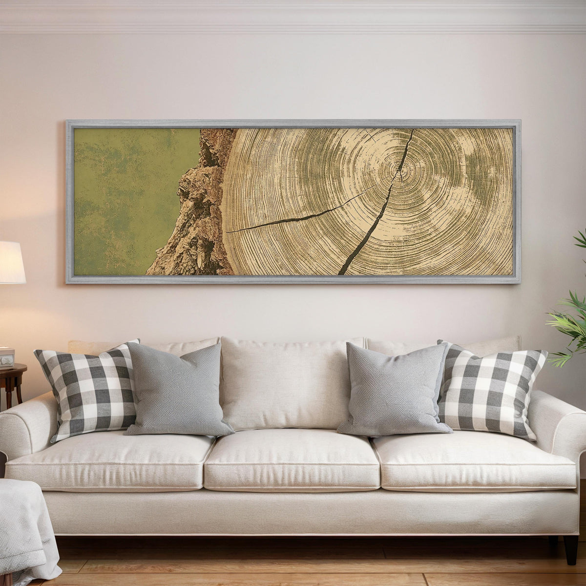 Golden tree ring wood grain panoramic canvas print above a white sofa in a bright living room