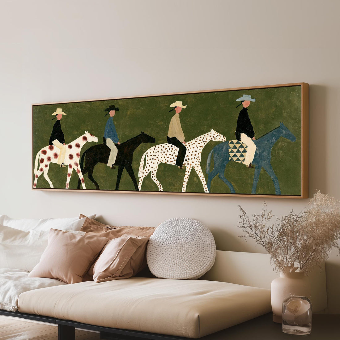 Spotted horse riders long horizontal canvas print above a sofa in a living room