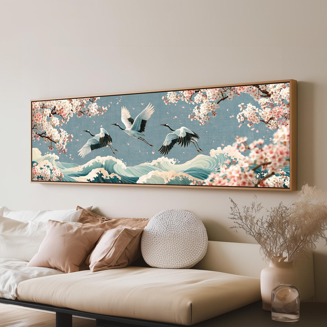 Cranes flying over waves and cherry blossoms long horizontal canvas print above a sofa in a living room