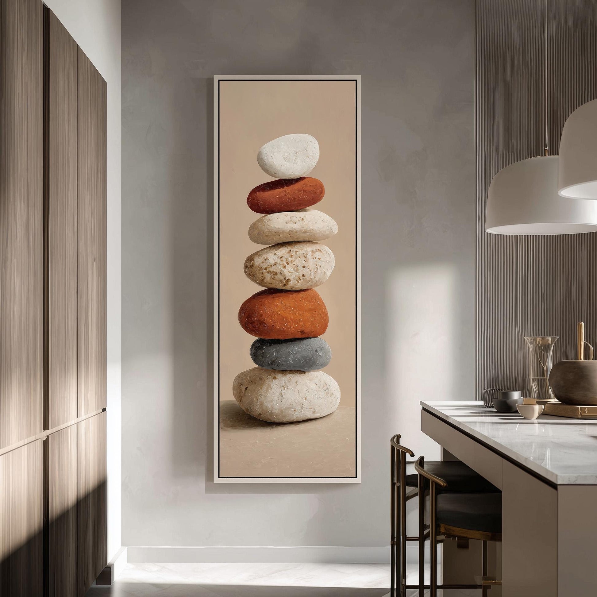 a large framed artwork depicting a stack of colorful rocks on a wall in a modern kitchen.