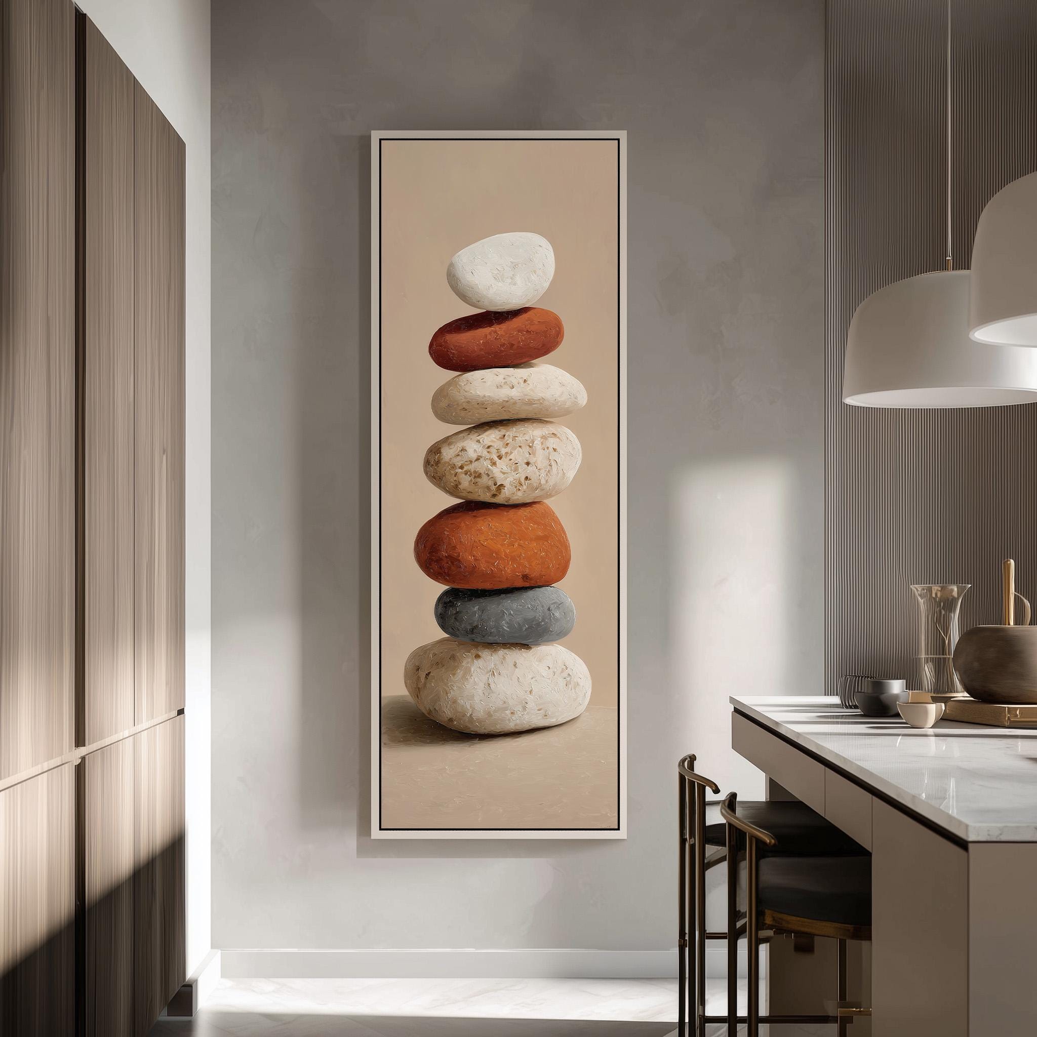 a large framed artwork depicting a stack of colorful rocks on a wall in a modern kitchen.