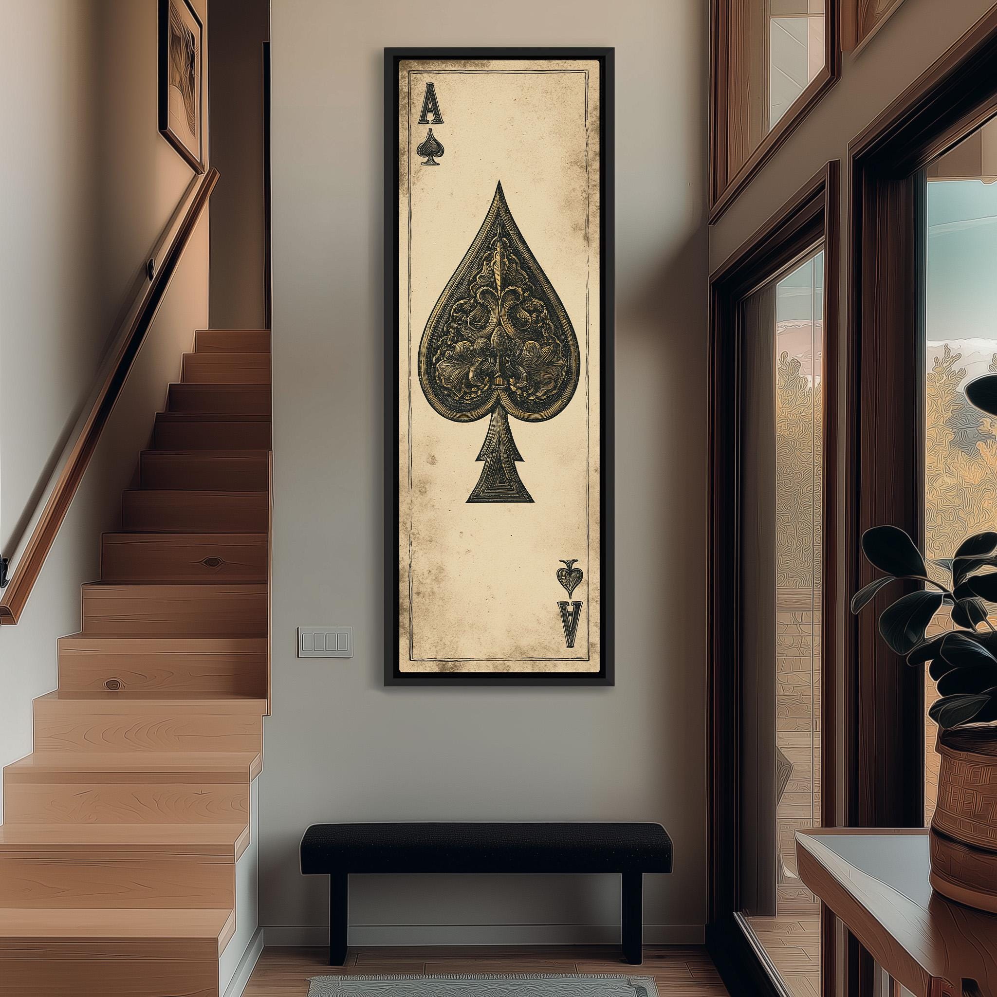 a large framed artwork of a spade, a playing card, hanging on the wall in a hallway.