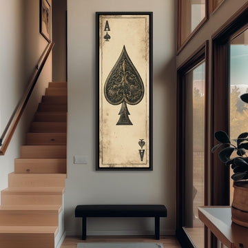 a large framed artwork of a spade, a playing card, hanging on the wall in a hallway.