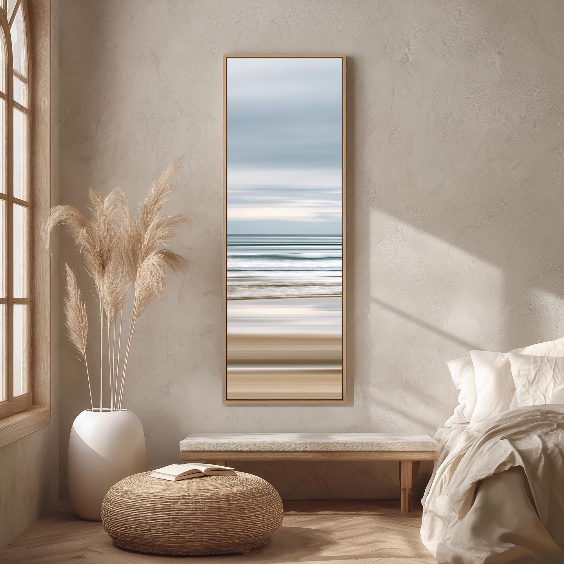 a serene bedroom scene with a large window, a painting of a beach, a white bench, a woven ottoman, and a potted plant.