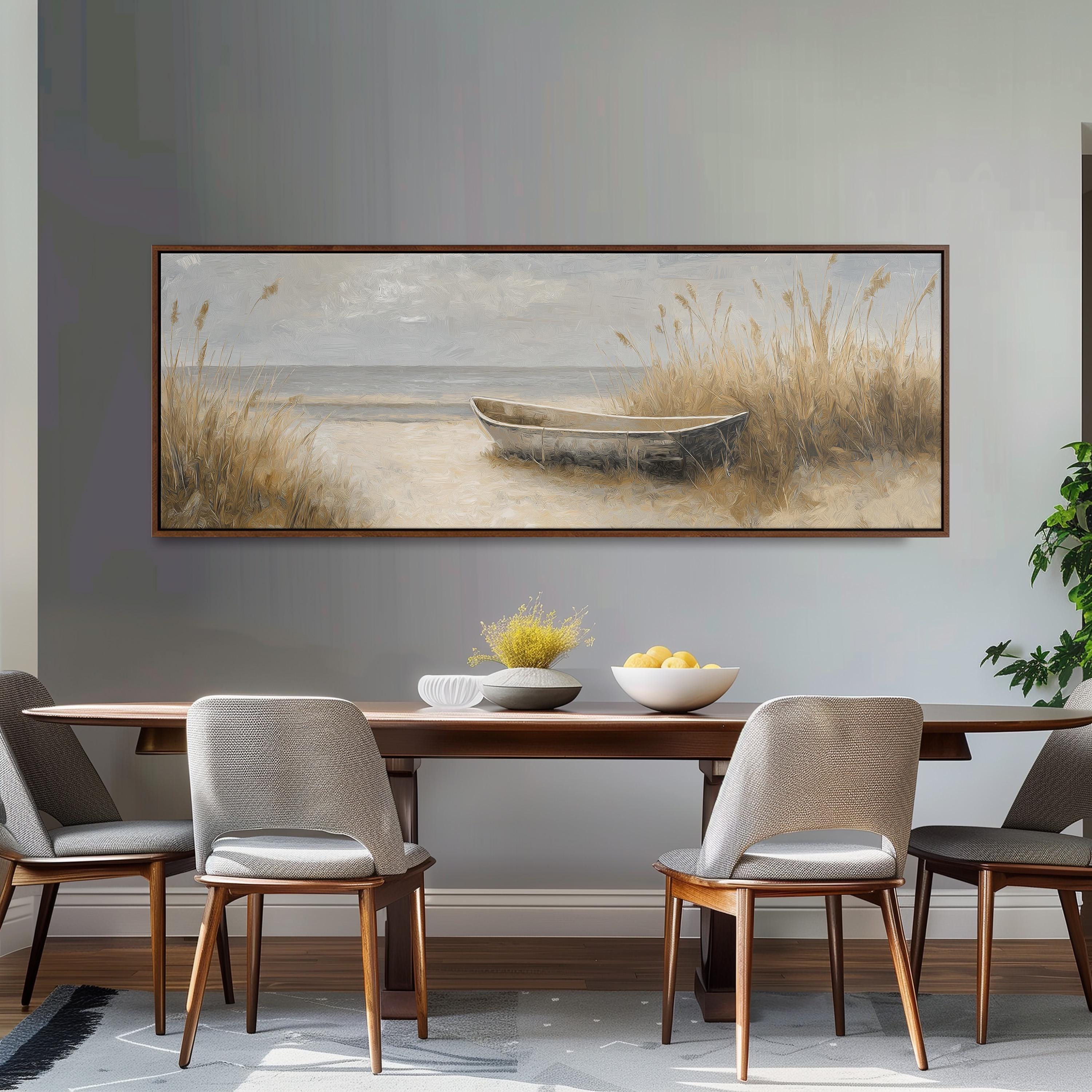 a dining room with a large painting of a boat on the wall above a wooden table with four chairs. The painting depicts a serene beach scene with a boat on the sand and tall grasses in the background.