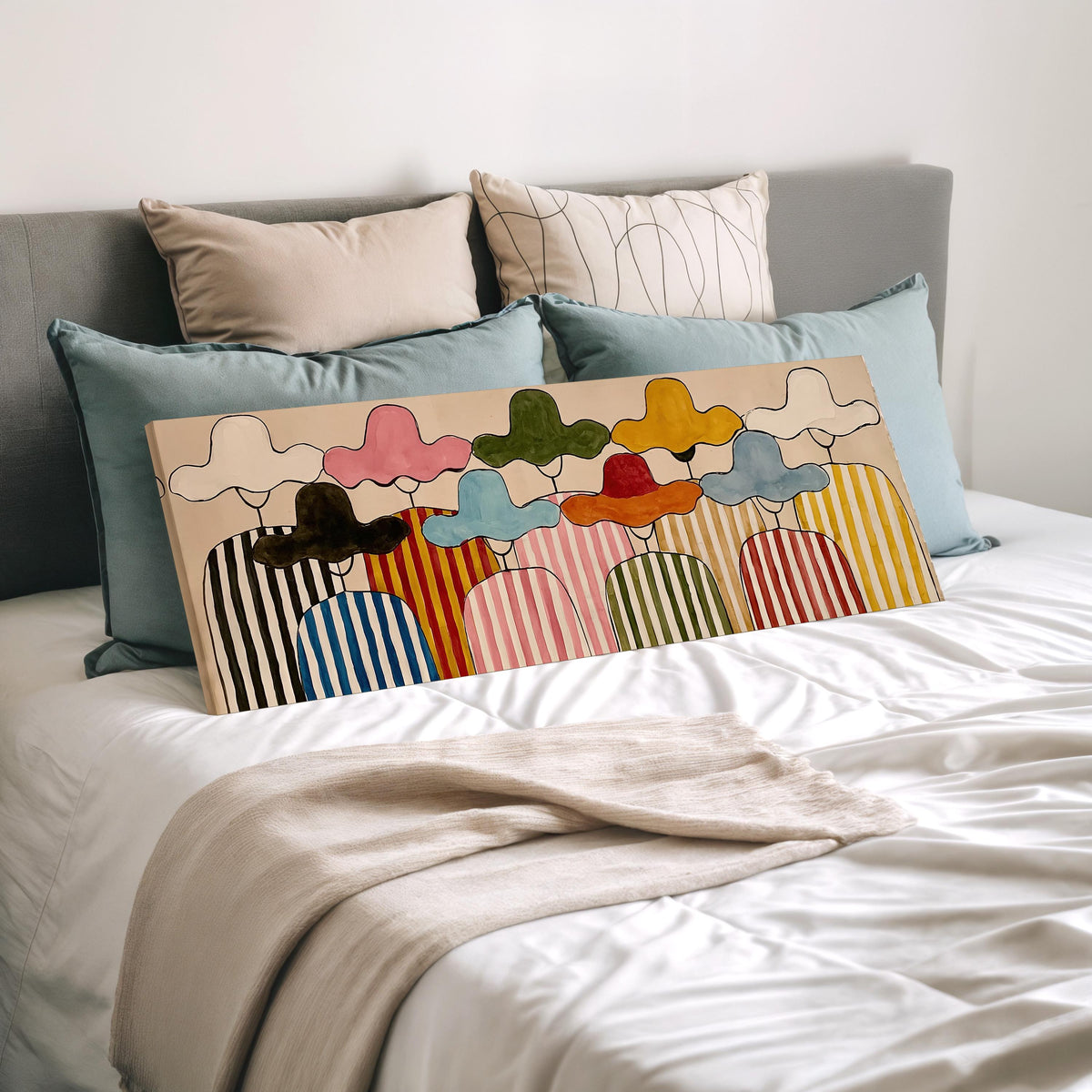Gathering of figures in straw hats and stripes wide panoramic canvas print laid on a bed to show its size