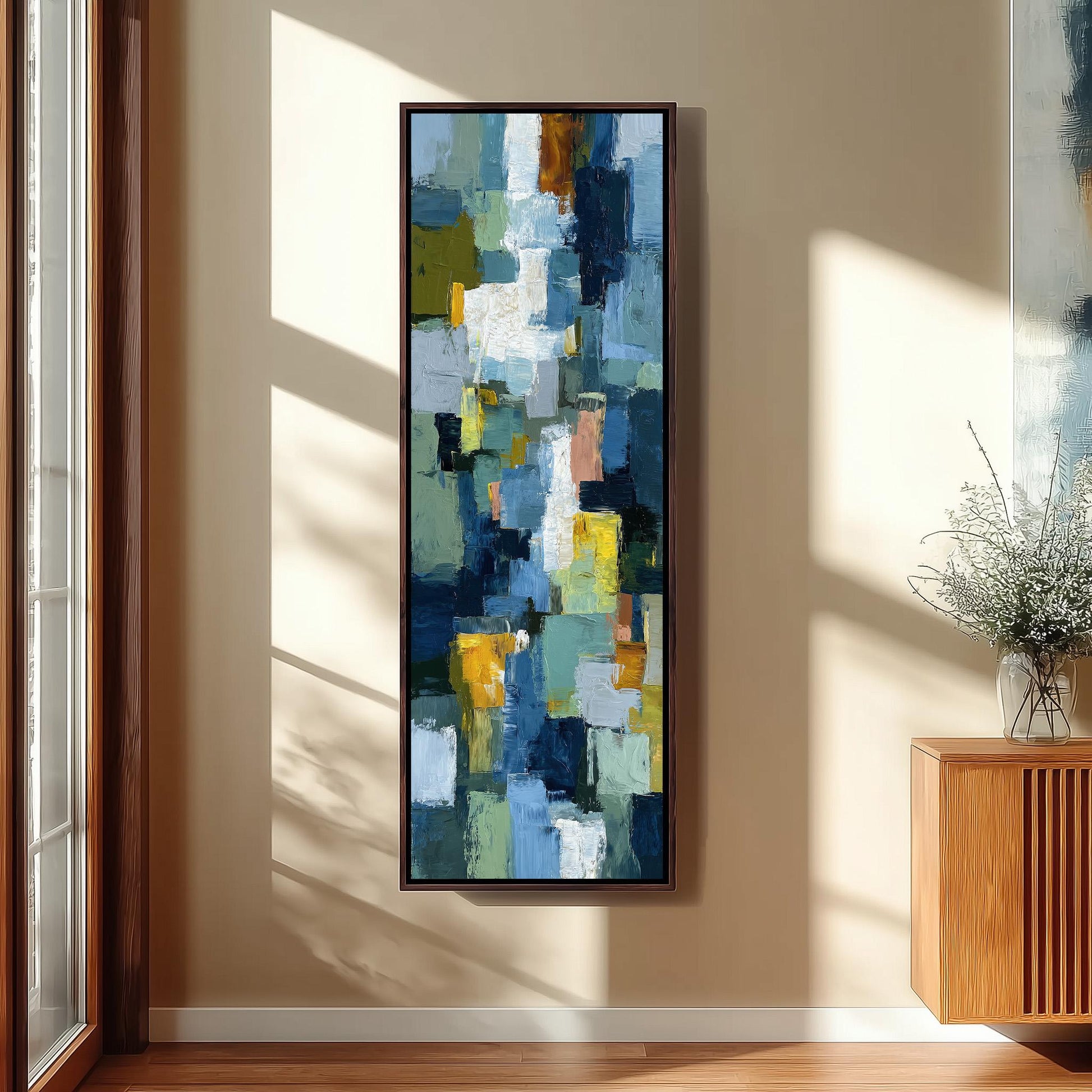 a large abstract painting hanging on a wall in a room with a wooden floor and a window.