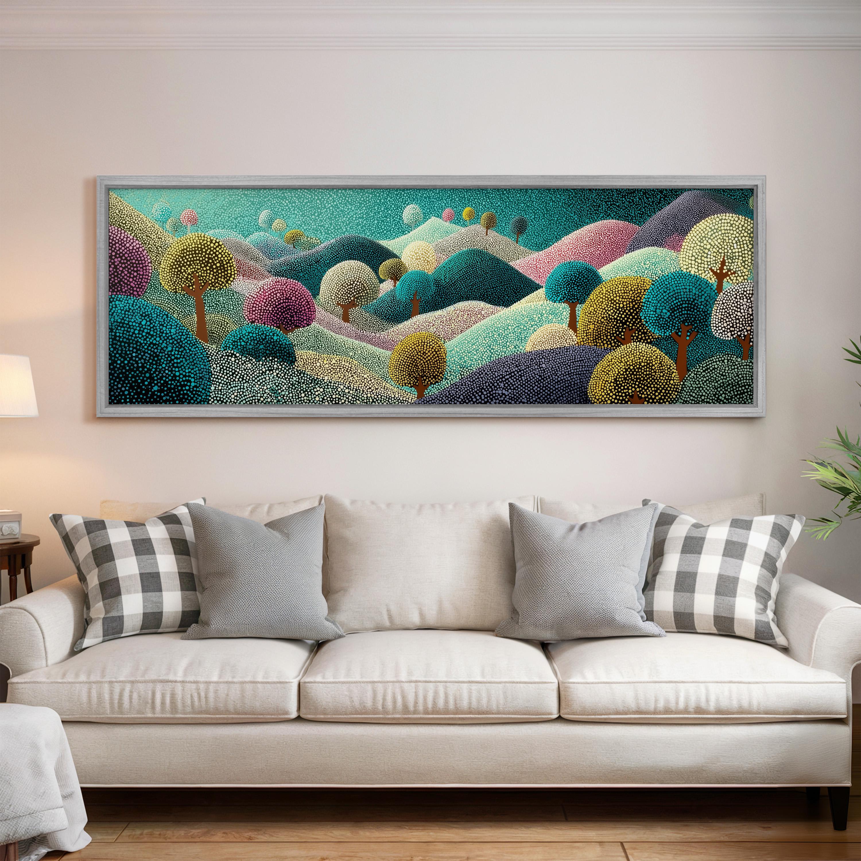 a large, colorful painting of a landscape hanging on a wall above a white couch with patterned throw pillows.