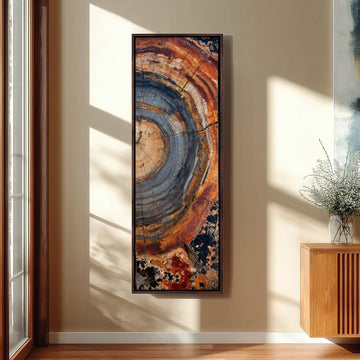 a large, colorful abstract painting hanging on a wall in a room with a wooden cabinet and a vase of flowers.