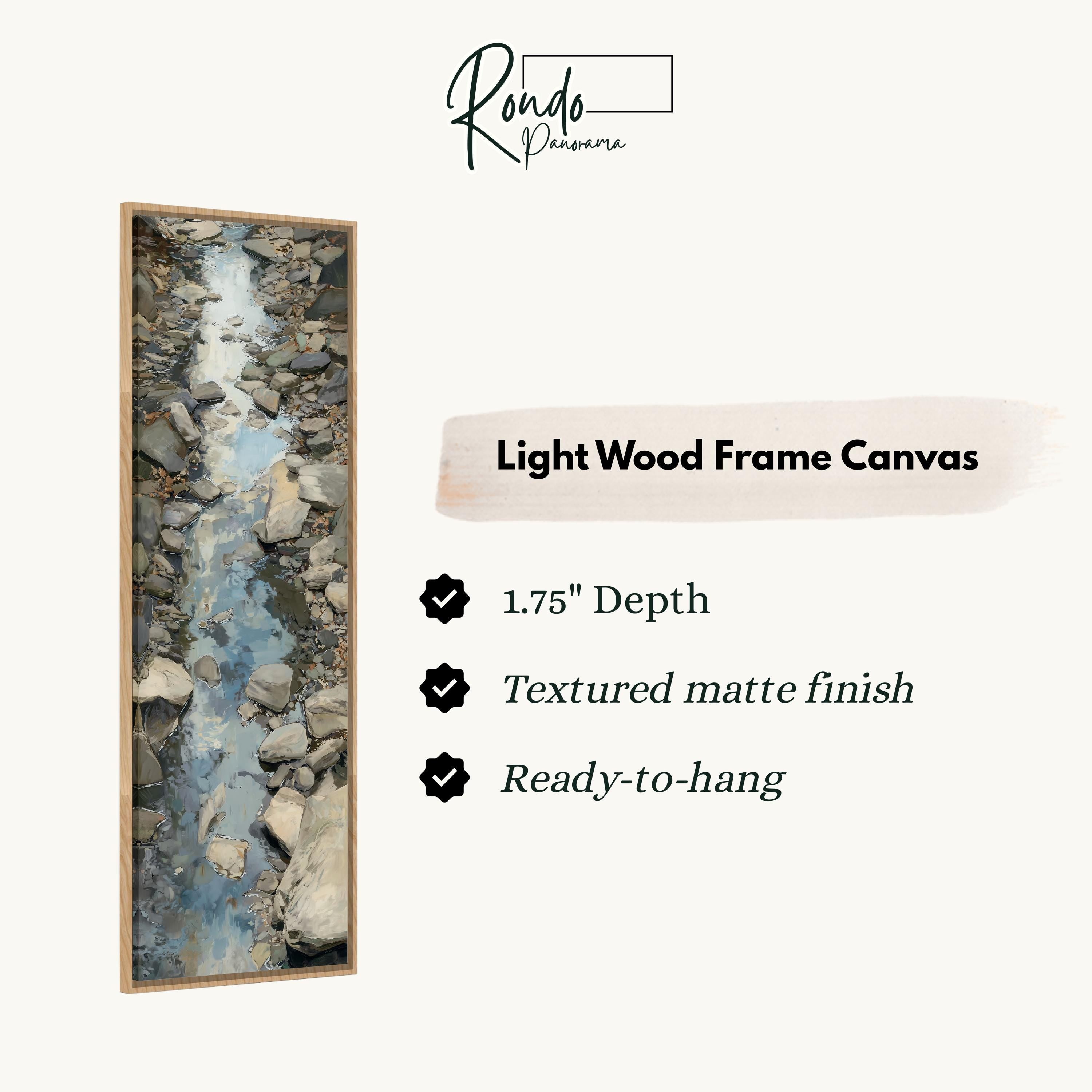 The image is a rectangular frame with a painting of a stream of water inside it. The frame is described as a light wood frame canvas, with a depth of 1.75" and a textured matte finish. It is ready to hang.