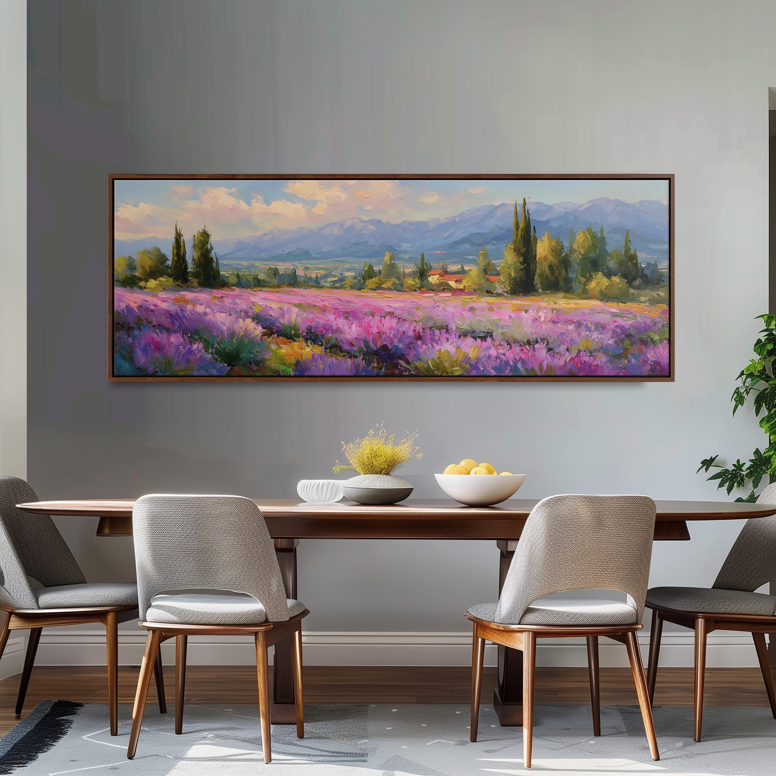 a large painting of a field of purple flowers hanging on a wall above a wooden dining table with four chairs.