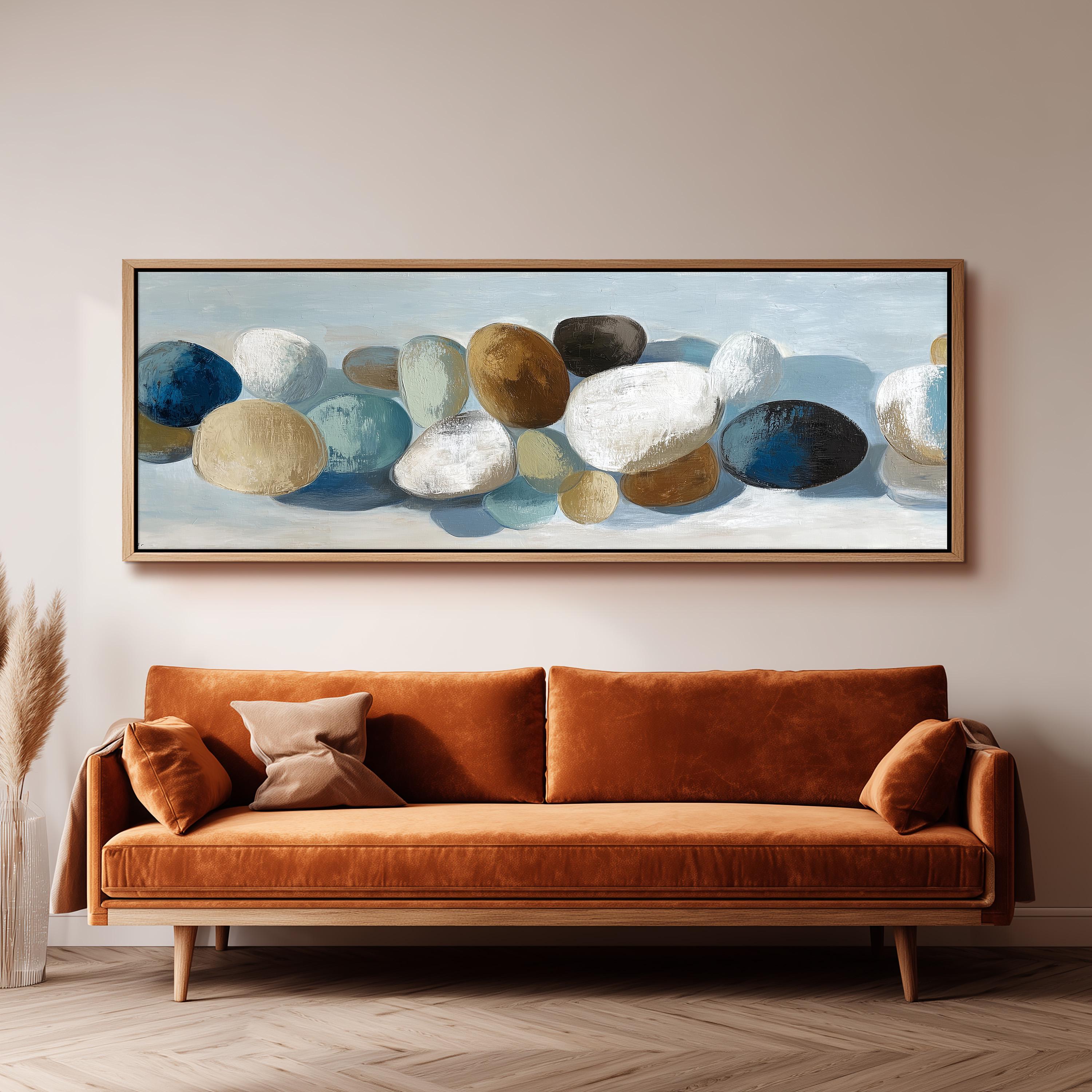 a large painting of various colored rocks hanging on a wall above a brown sofa.