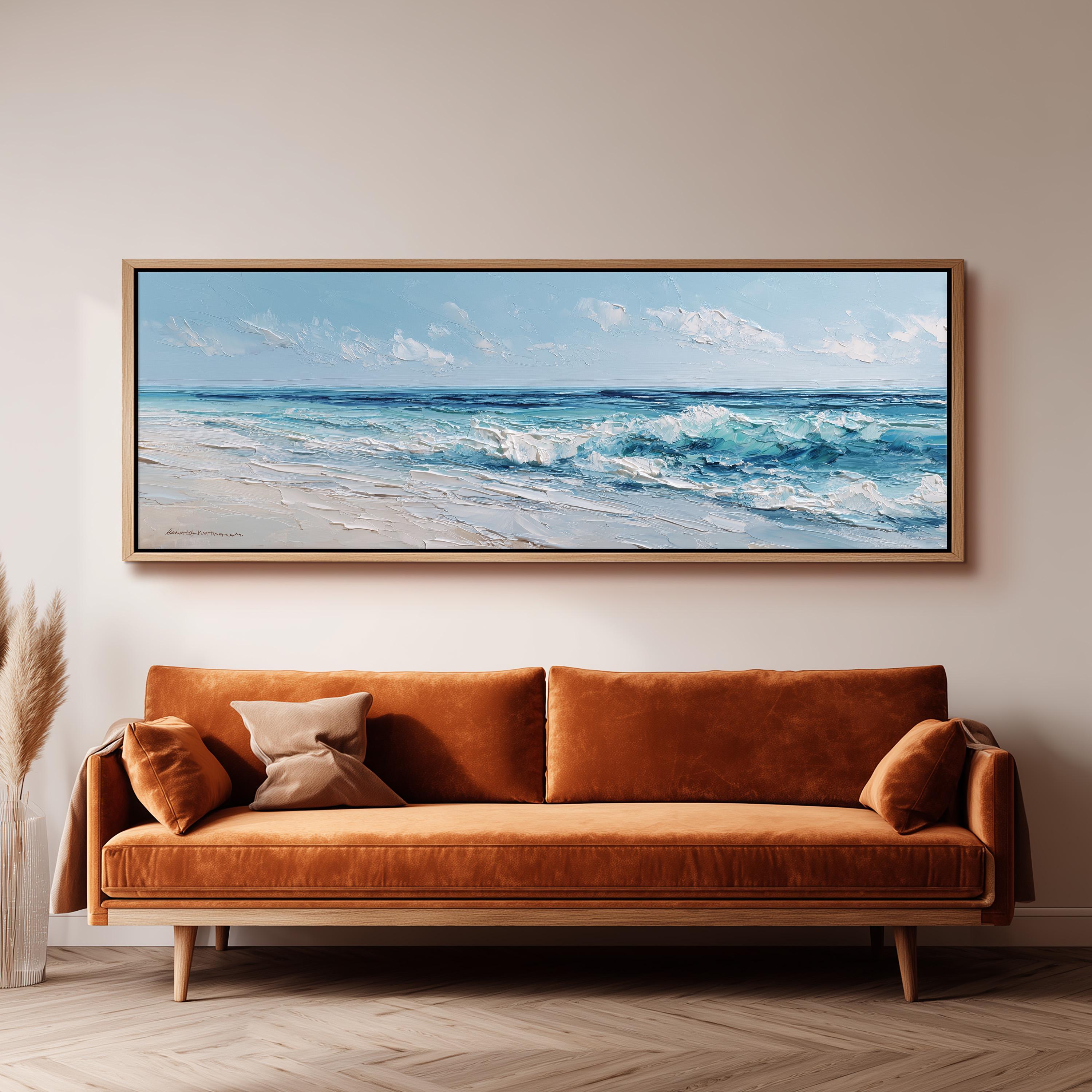 a large, framed painting of a beach scene hanging on a wall above a brown sofa.