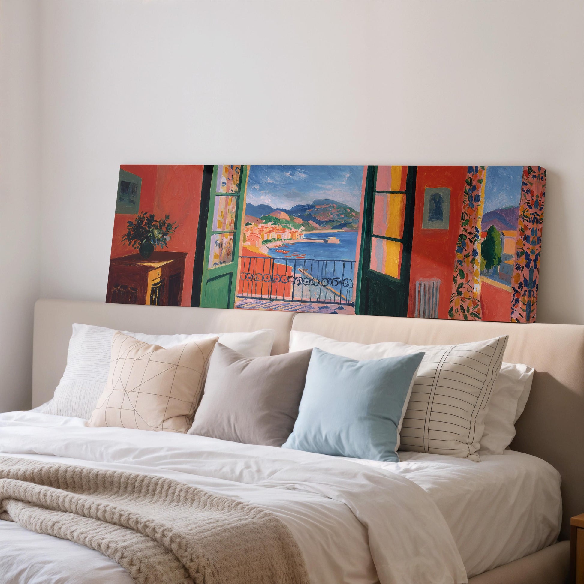 a large, colorful painting of a balcony overlooking a scenic landscape, which is displayed on the wall above a bed with white bedding and pillows.