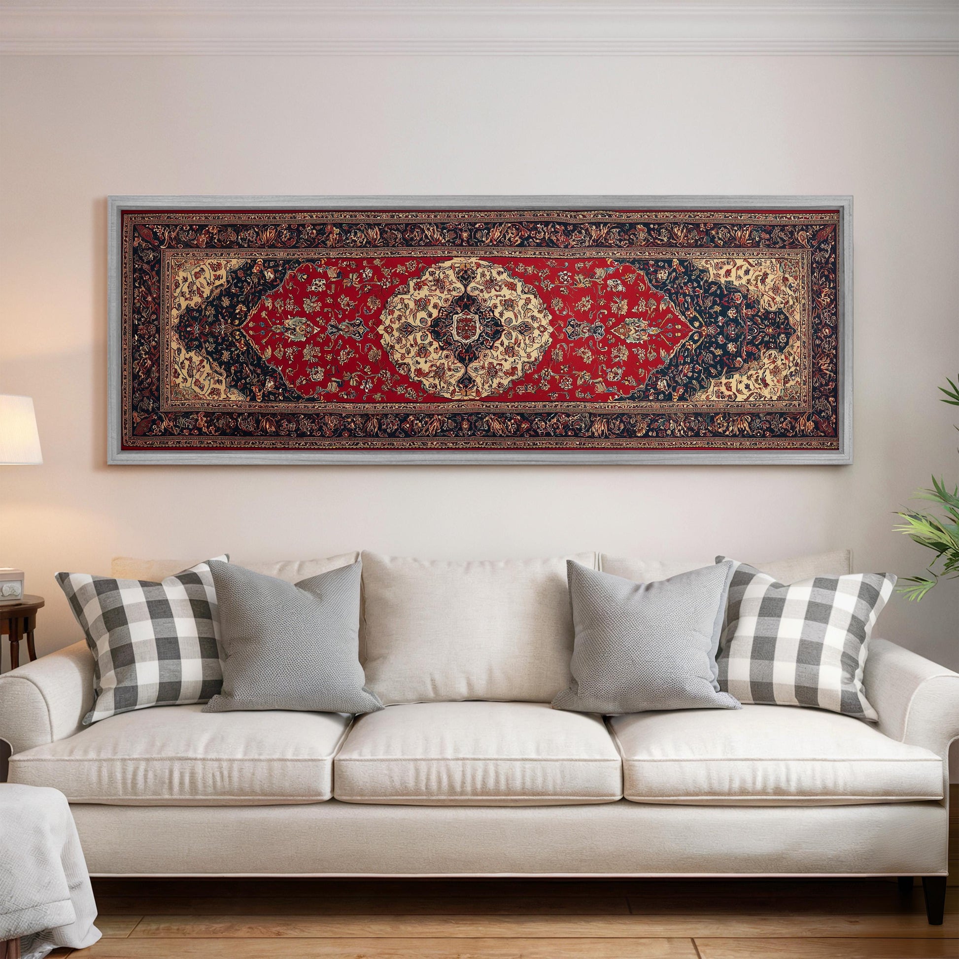 a large, ornate rug hanging on a wall above a white couch with gray and white plaid throw pillows.