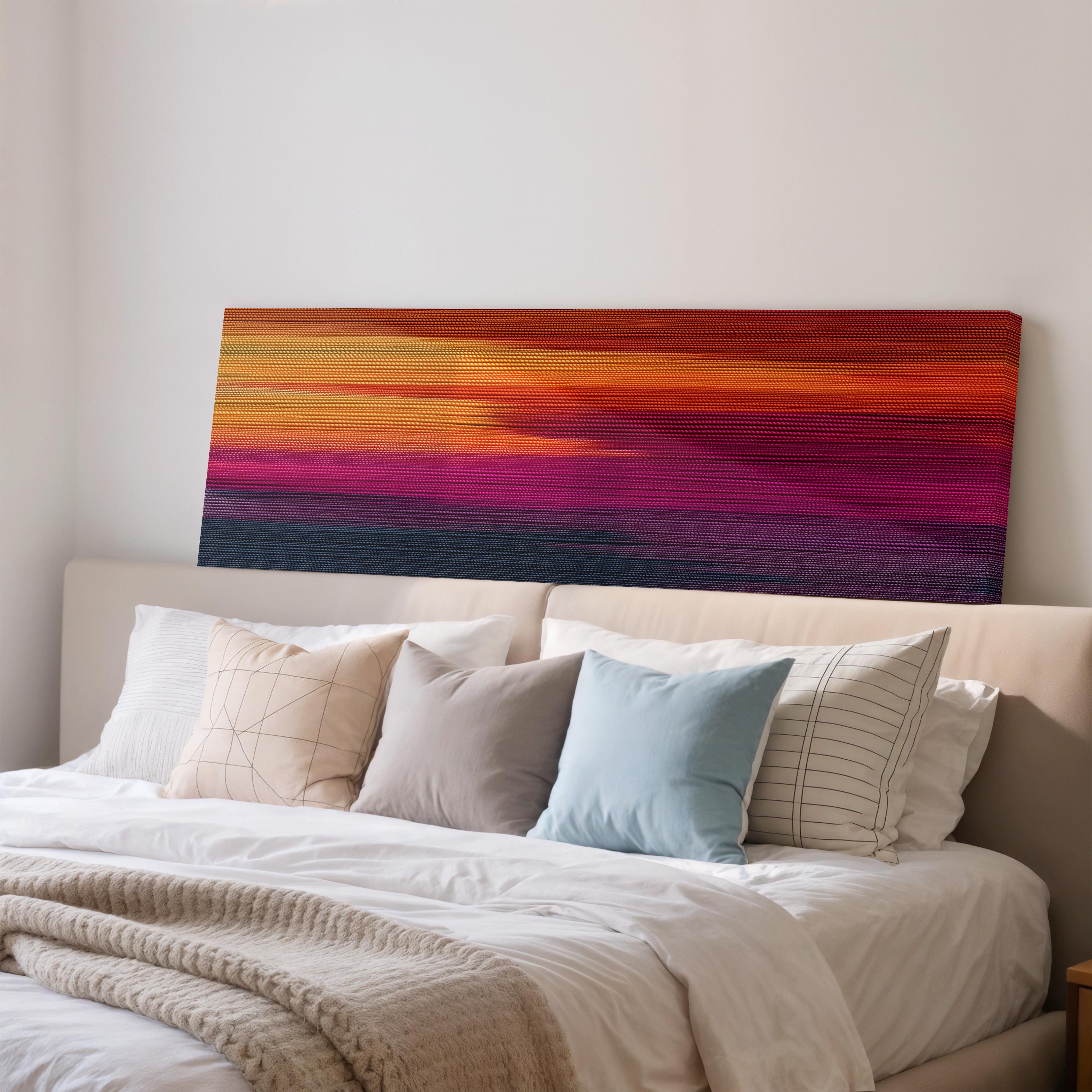 a large bed with a white headboard and a colorful abstract painting hanging above it.