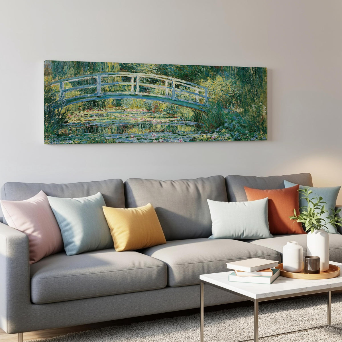 Japanese bridge over a water lily pond panoramic canvas print above a grey sofa in a living room