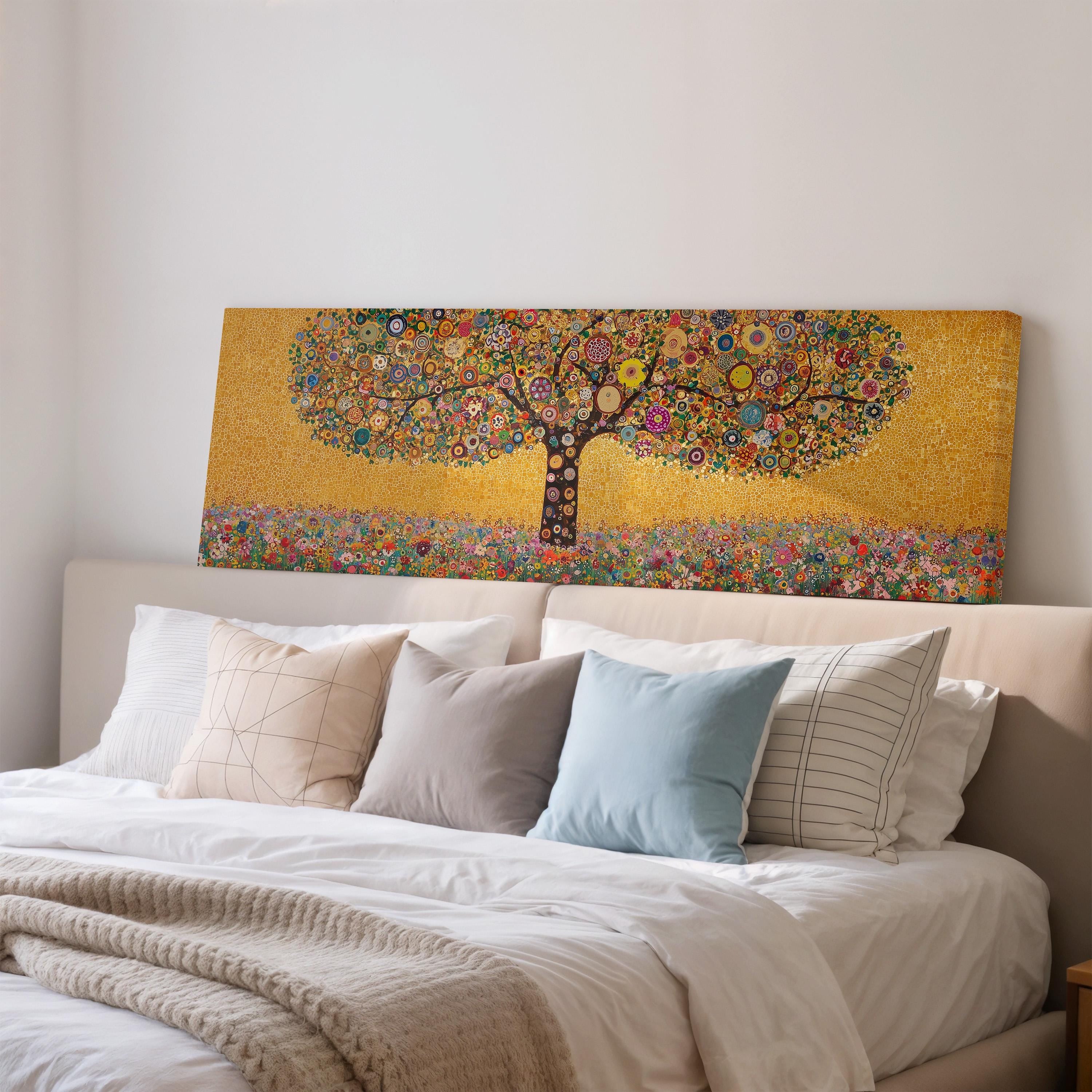 a large, colorful painting of a tree with a golden background, hanging above a bed with white pillows and a gray blanket.
