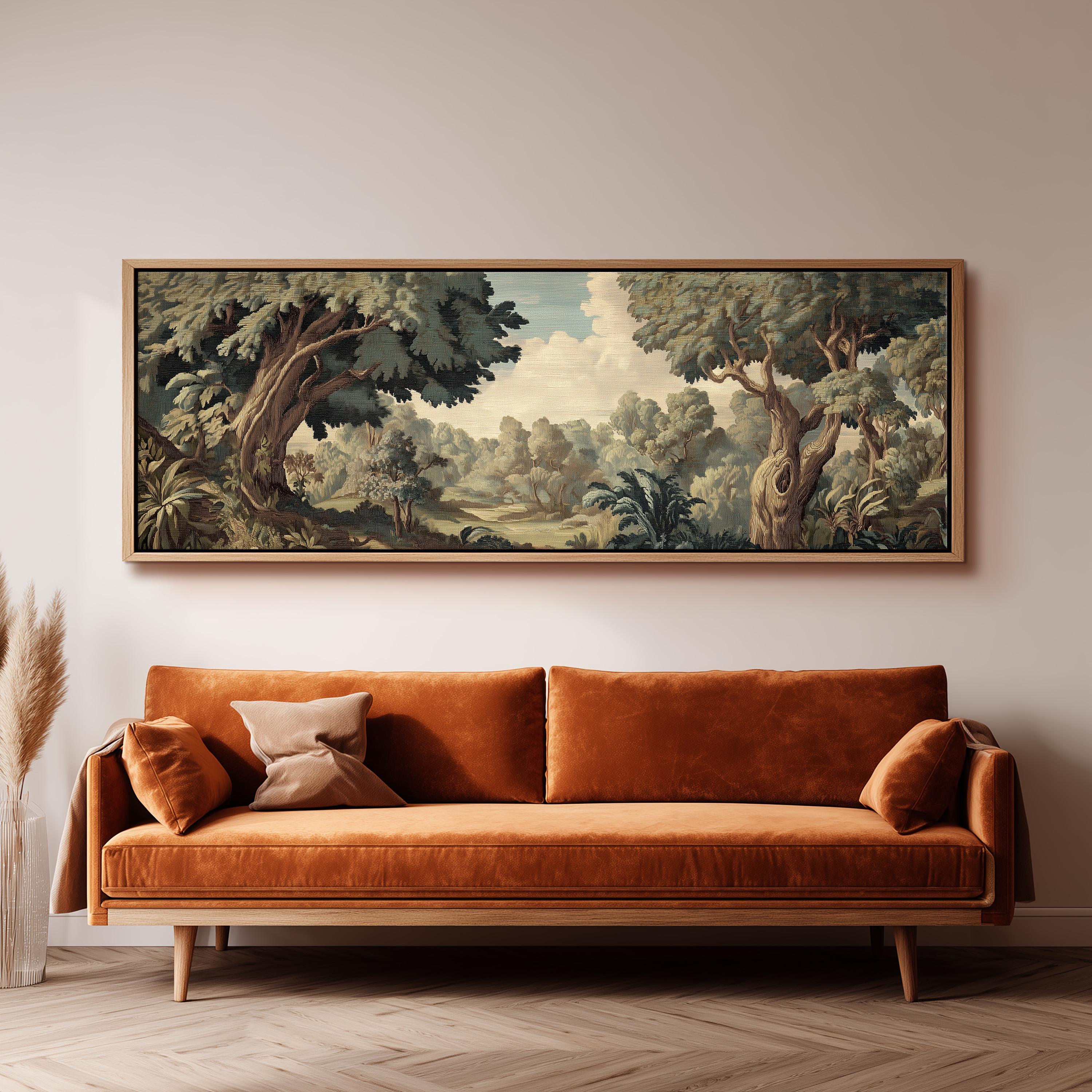 a large, framed painting of a lush, forested landscape hanging on a wall above a brown sofa with orange cushions.