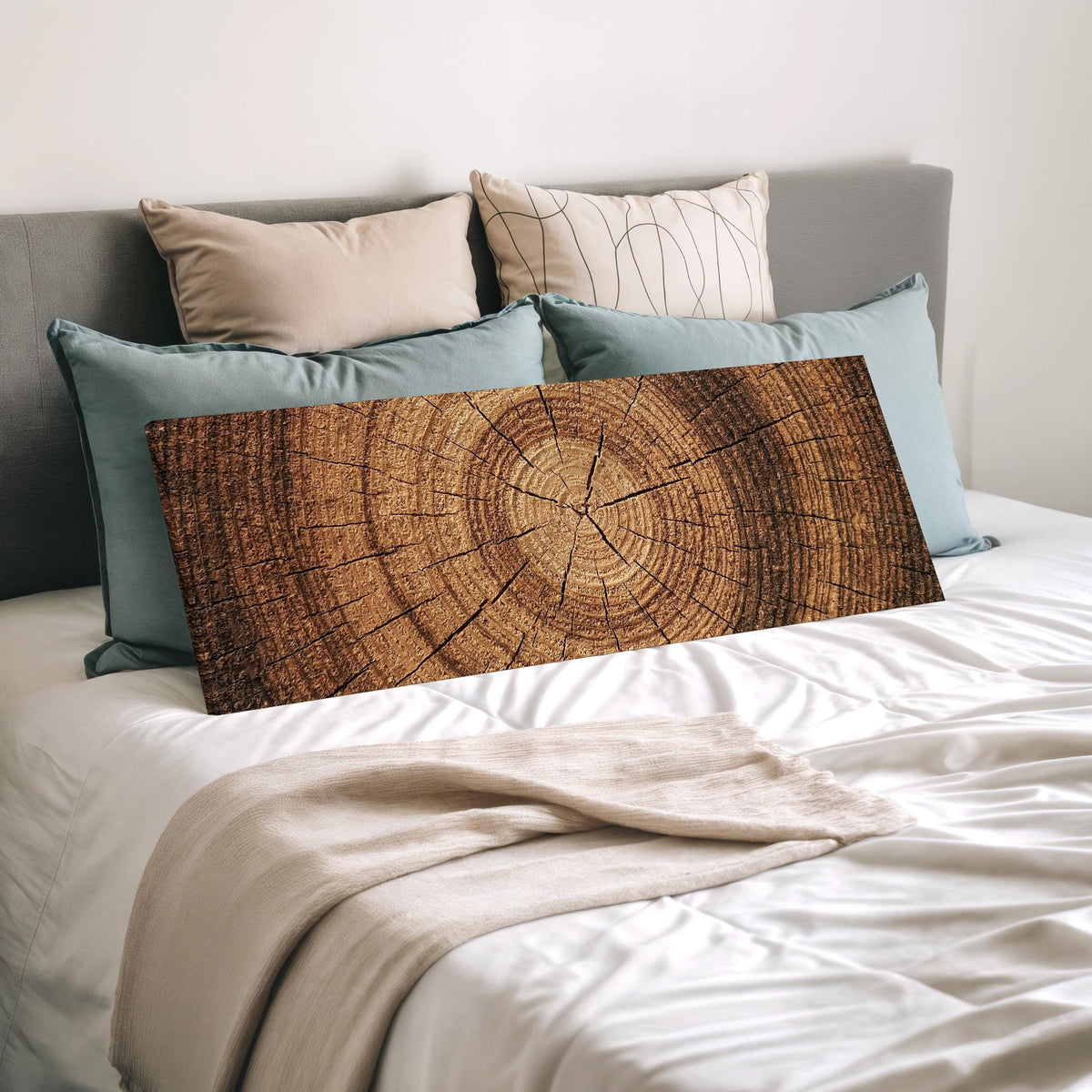 Warm oak wood ring wide panoramic canvas print laid on a bed to show its size