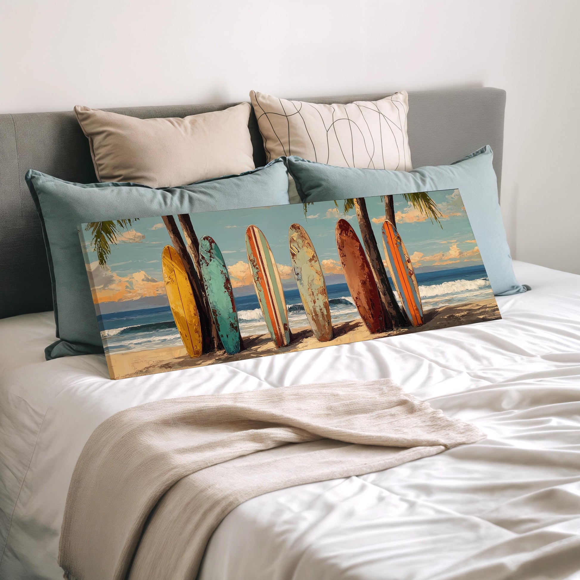 a bed with a large canvas print of a beach scene, including a row of colorful surfboards leaning against a wall.