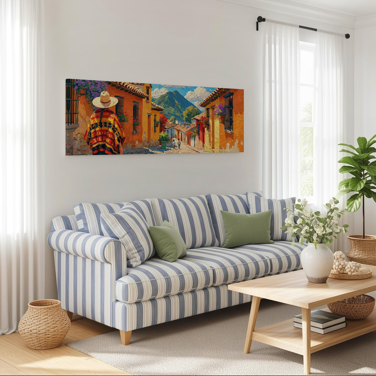 Colorful Guatemalan street with volcano view long horizontal canvas print above a striped sofa in a coastal living room
