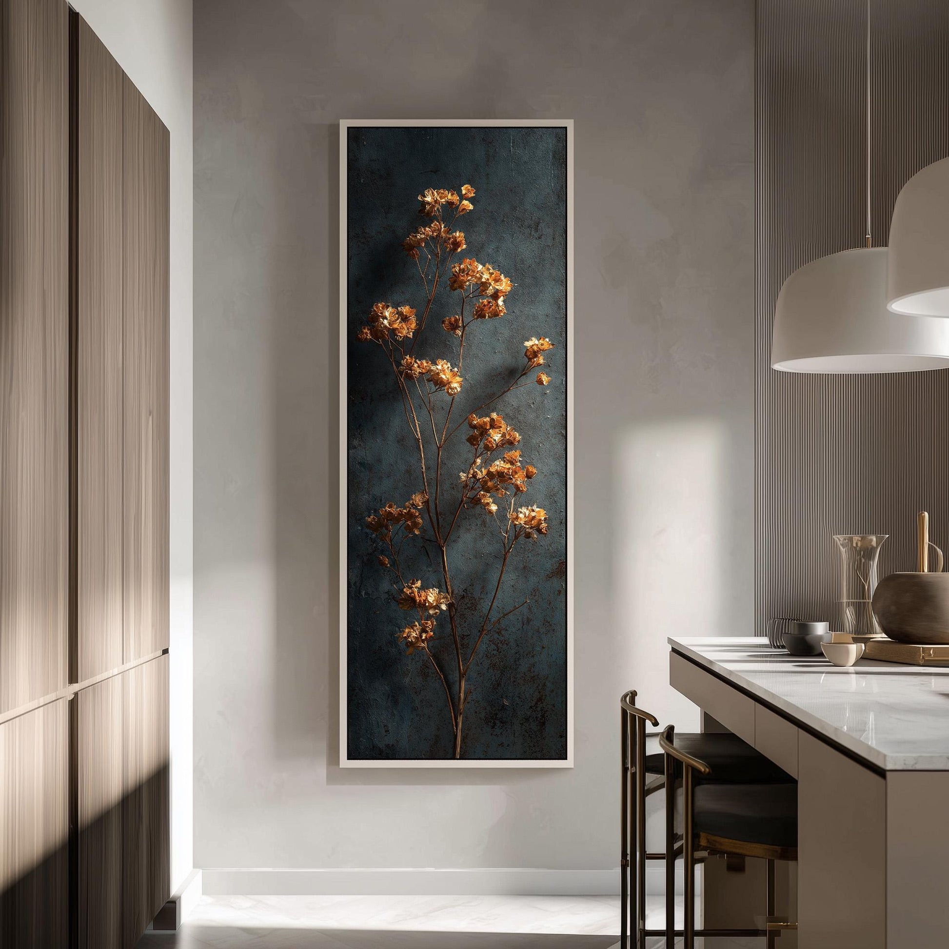 a modern kitchen with a large framed artwork of a tree with orange flowers hanging on the wall. The kitchen has a white countertop and a wooden cabinet, creating a clean and minimalist aesthetic.