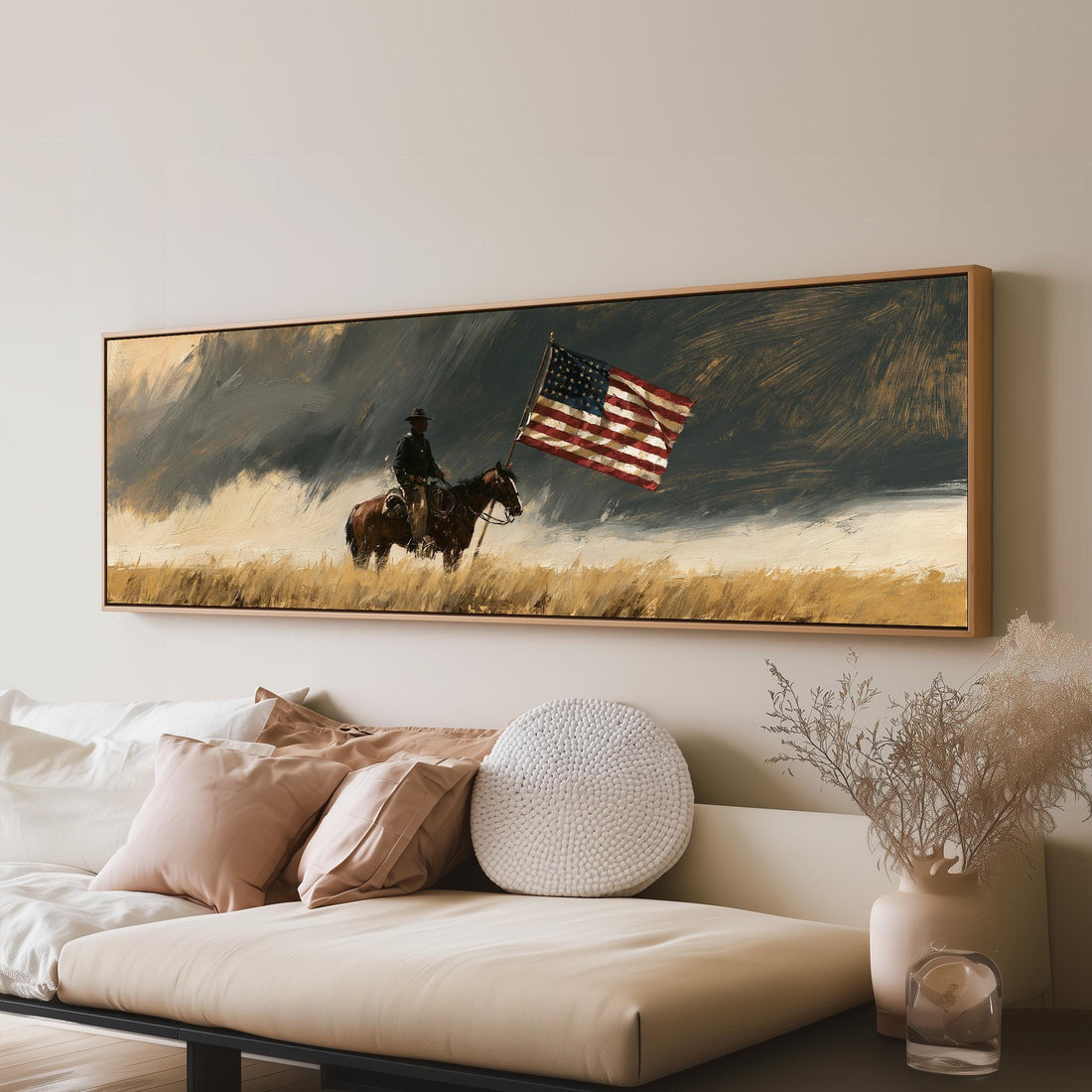 Cowboy riding with an American flag under a stormy sky long horizontal canvas print above a sofa in a living room