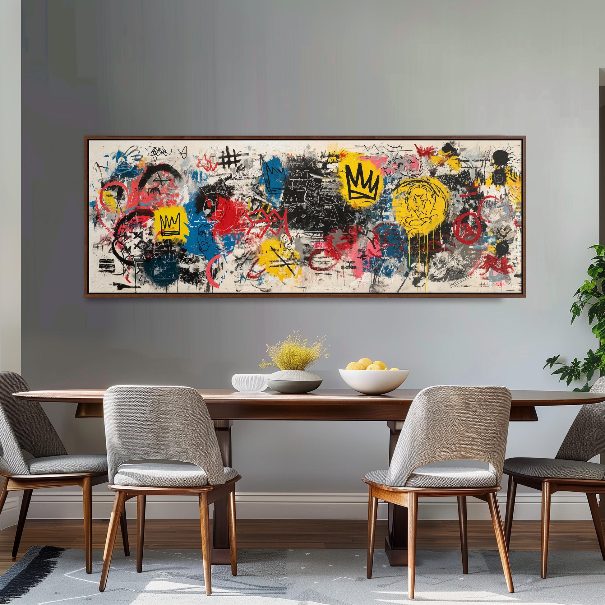 a dining room with a large, colorful abstract painting hanging on the wall above a wooden dining table. The table is set with a bowl of fruit and a vase, creating a welcoming and artistic atmosphere.