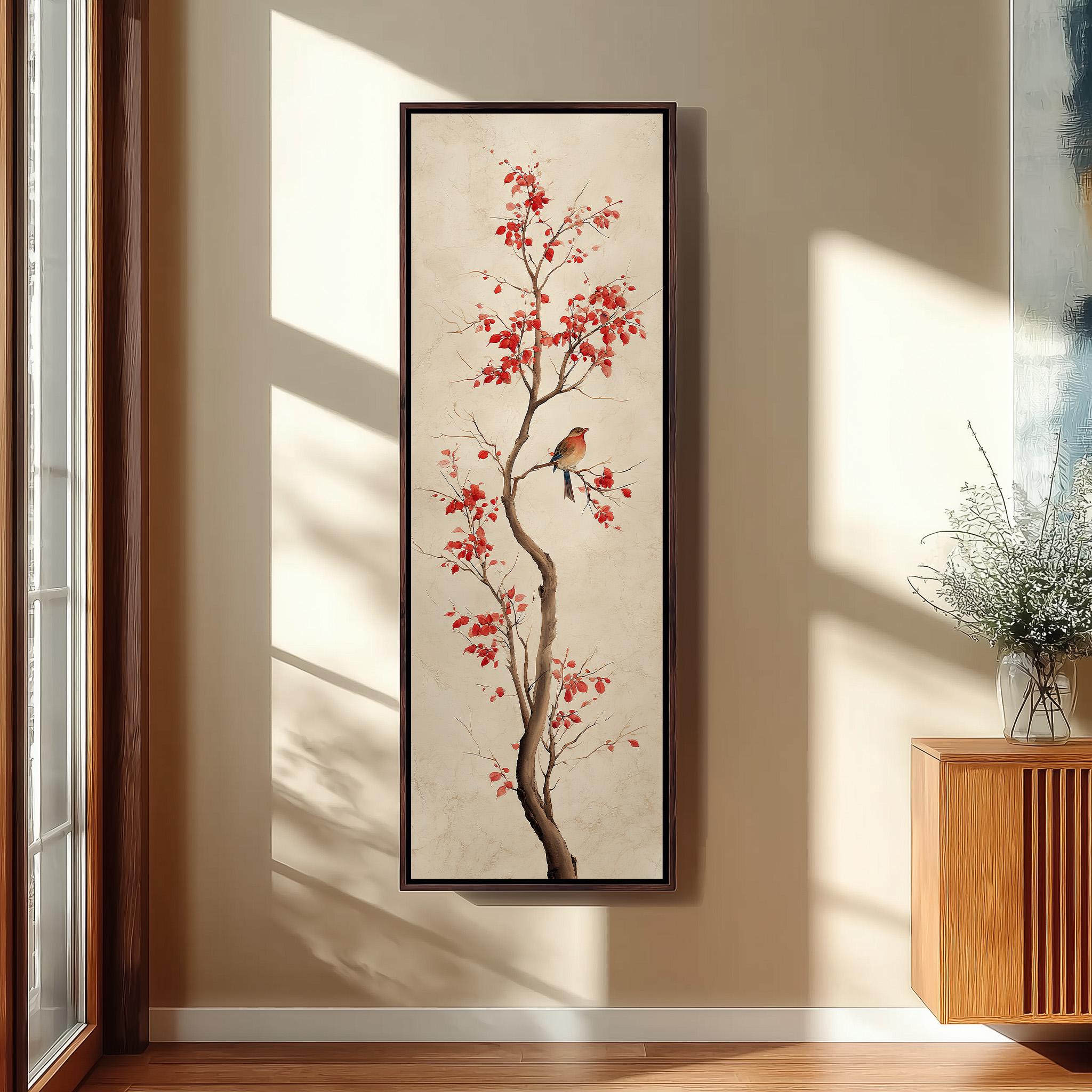 a large, framed painting of a tree with red leaves and a bird perched on one of the branches. The painting is hanging on a wall in a room with a wooden cabinet and a vase of flowers nearby.