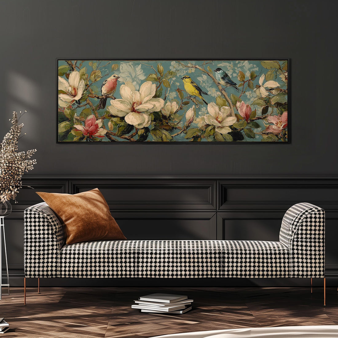 a large, framed painting of a floral scene with birds perched on branches, hanging on a wall above a brown sofa.