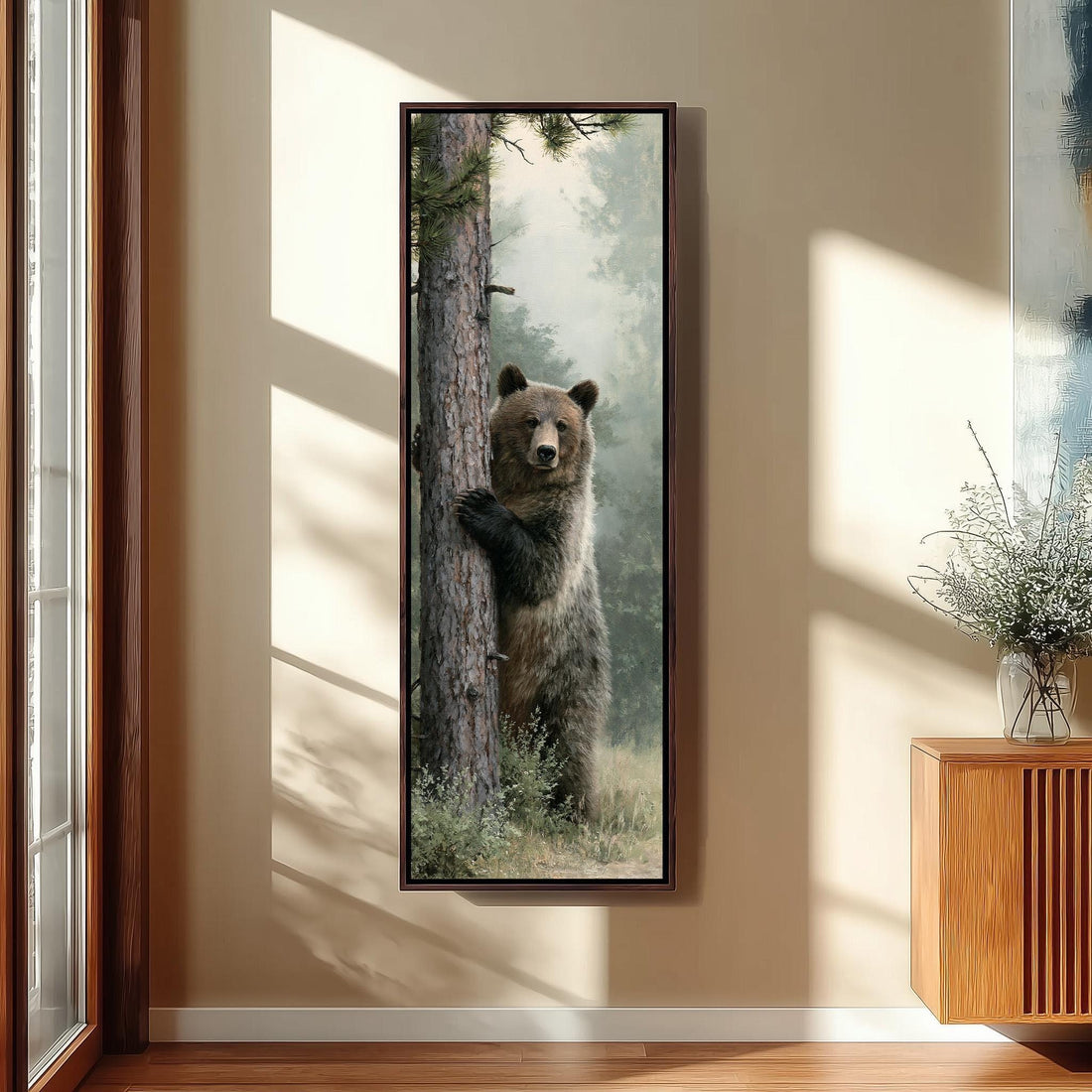 Brown bear standing against a pine tree long vertical canvas print in a sunlit living space