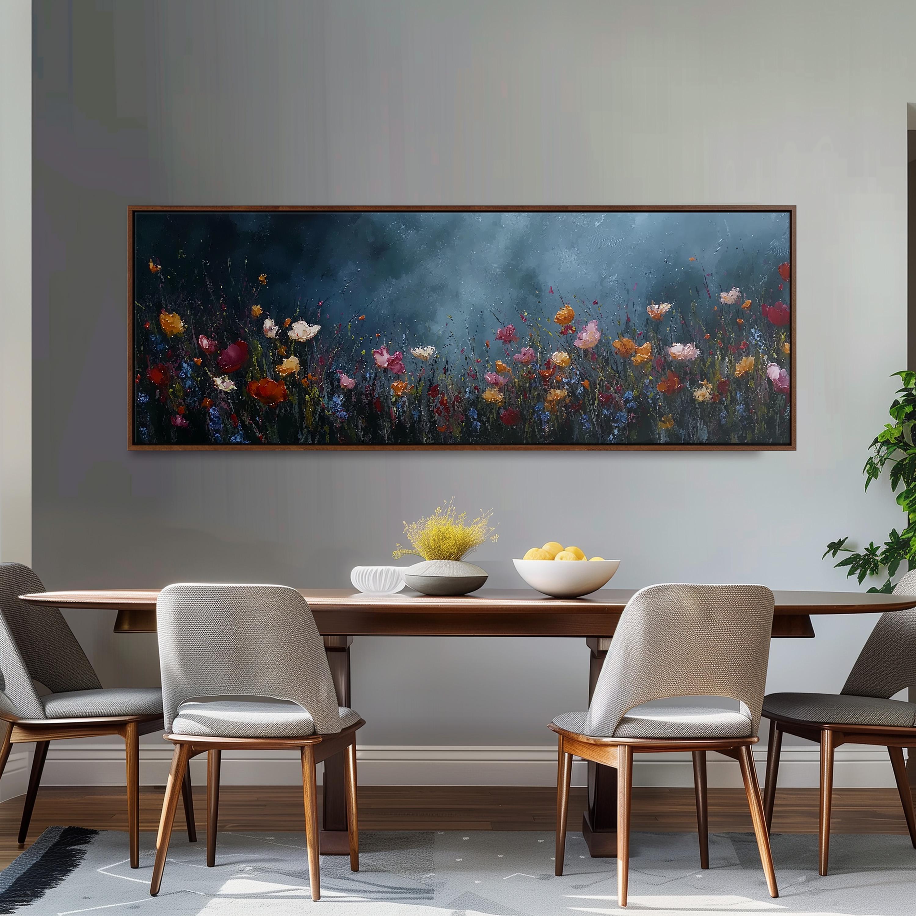 a dining room with a large painting of a field of flowers hanging on the wall above a wooden dining table with four chairs. The table is set with a bowl of fruit and a vase of flowers, creating a cozy and inviting atmosphere.
