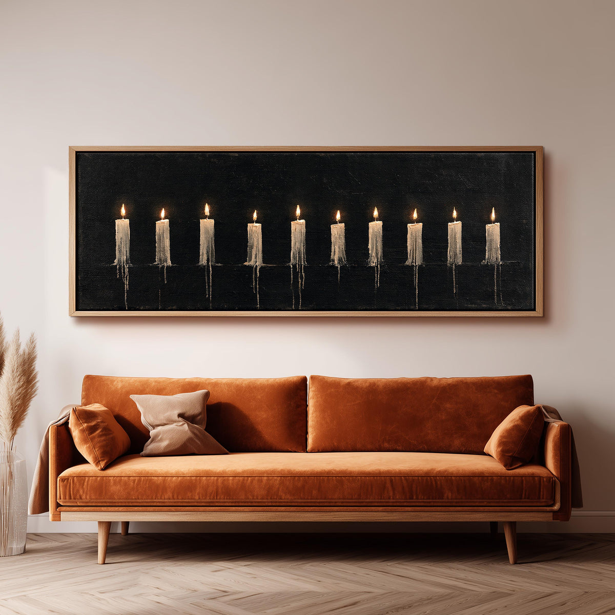 Ten lit candles on black wide panoramic canvas print above a bench in a dark living room