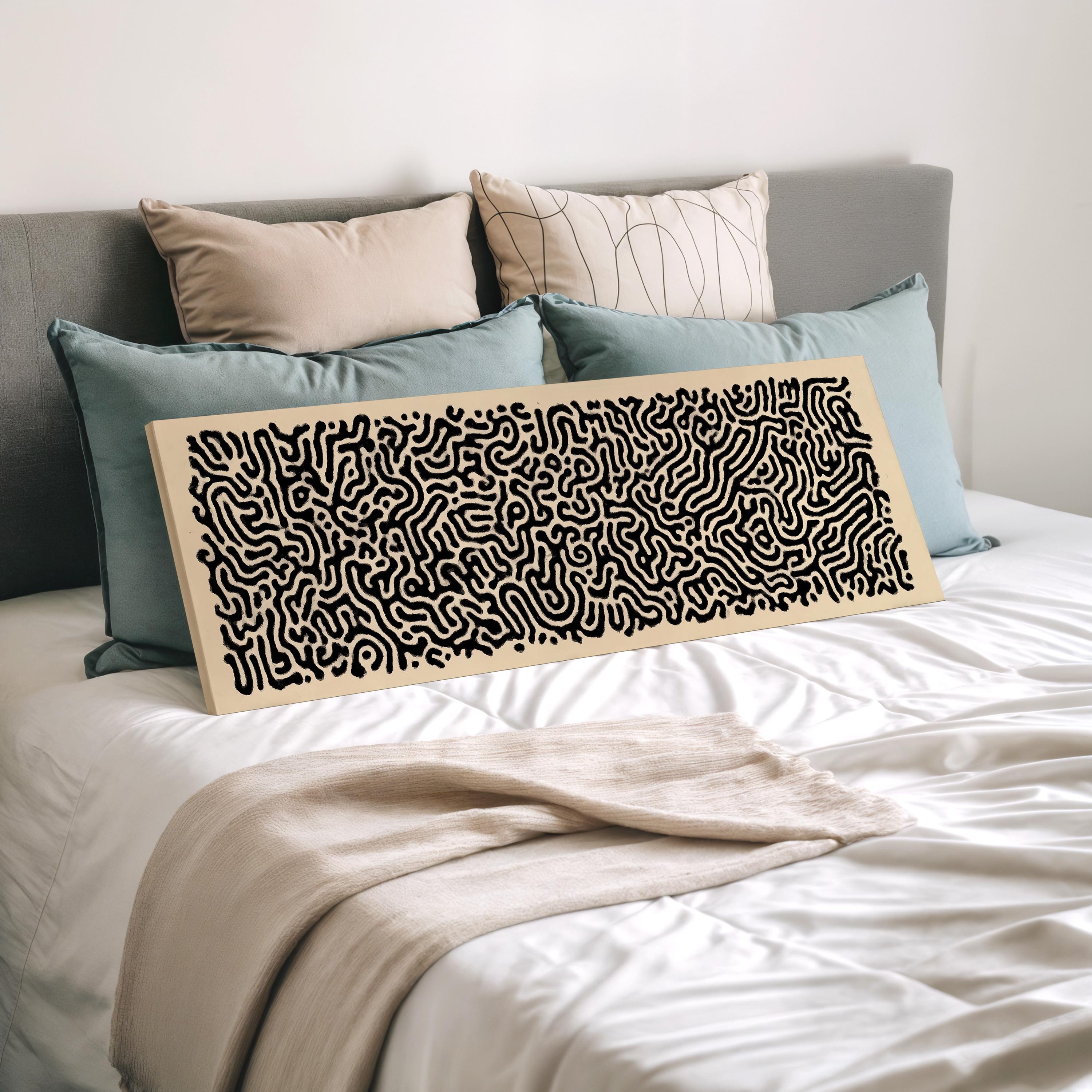 a bed with a white comforter and a large abstract artwork or painting displayed on it. The artwork features a black and white pattern.