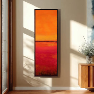 a large, vibrant abstract painting hanging on a wall, with a wooden cabinet and a vase of flowers to the right of the painting.