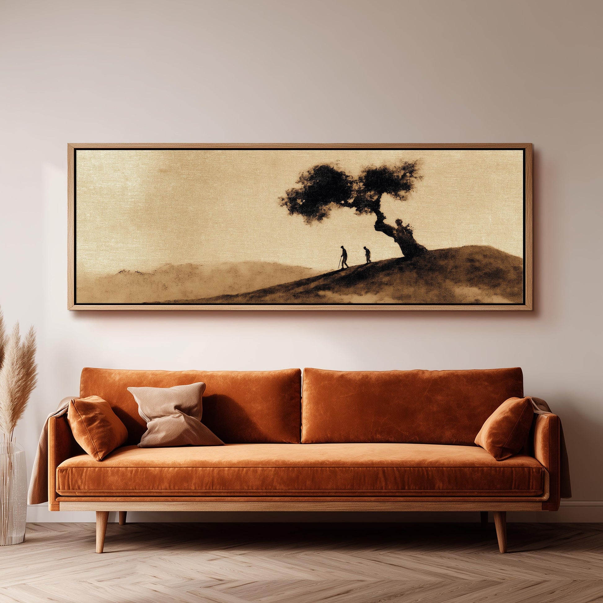 a large, framed painting of a tree and two people on a hill, hanging on a wall above a brown sofa.