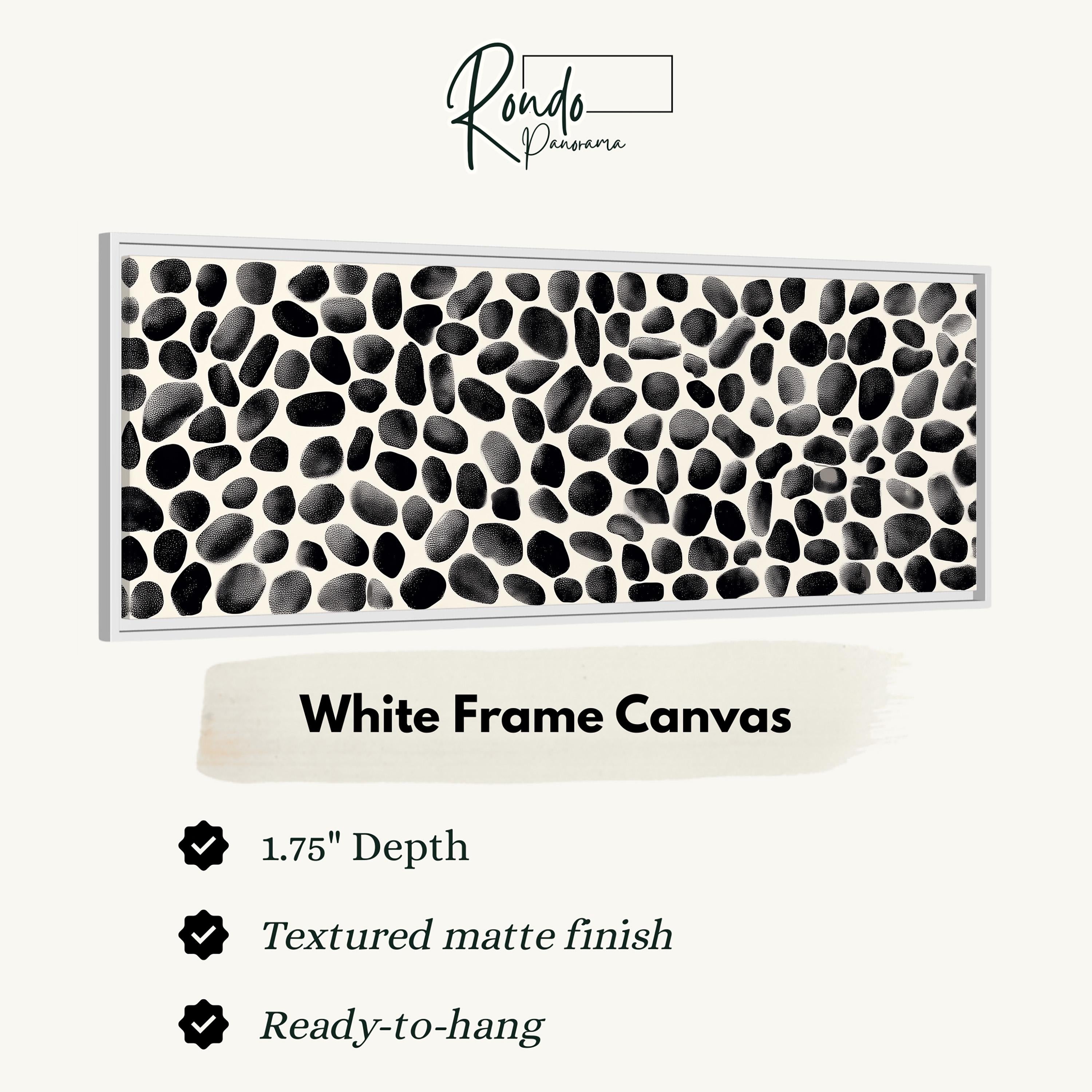 The image is a product description for a white frame canvas. It features a close-up of a white frame canvas with a black and white abstract pattern, and provides details about the product, including its dimensions, finish, and hanging capabilities.