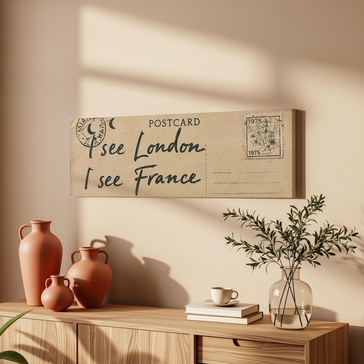 Postcard saying I see London, I see France long horizontal canvas print above a wooden sideboard