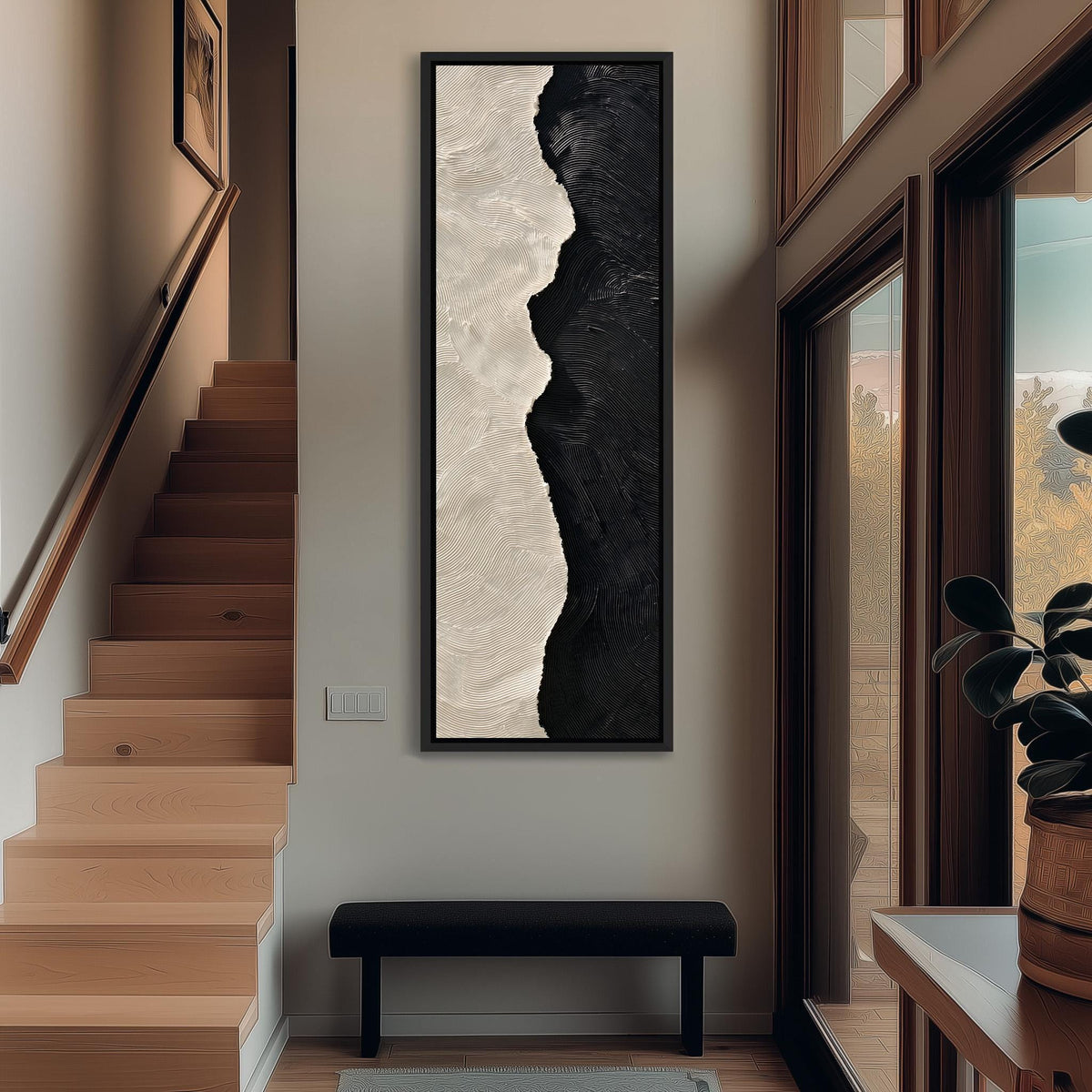 Black and cream textured brushstroke tall narrow canvas print beside a staircase in an entryway