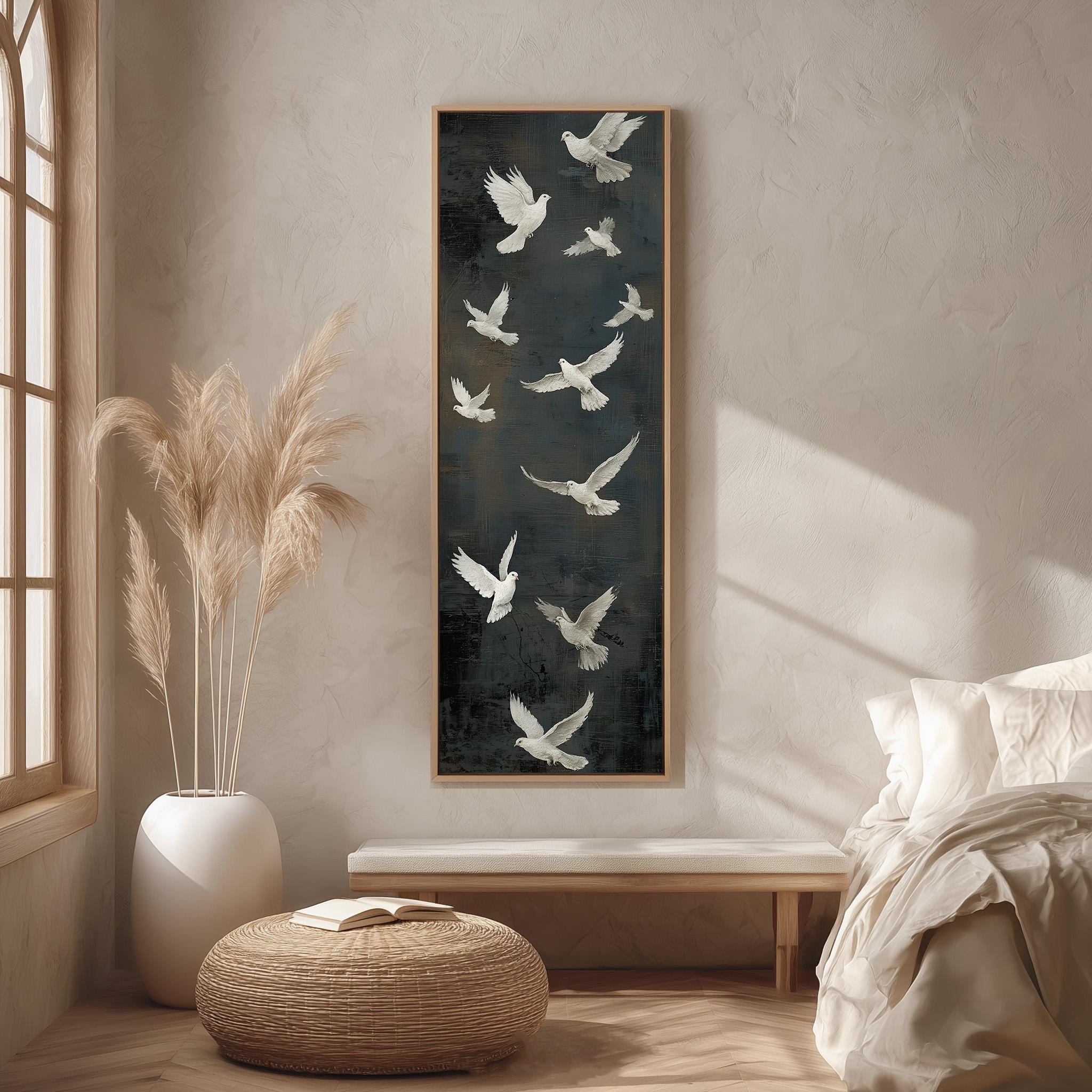 a serene and minimalist bedroom setting, featuring a large black and white painting of birds in flight as the focal point. The painting is hung on a wall above a wooden bench, which is positioned in front of a window. The room is decorated with a white bed, a woven ottoman, and a potted plant, creating a calm and peaceful atmosphere.